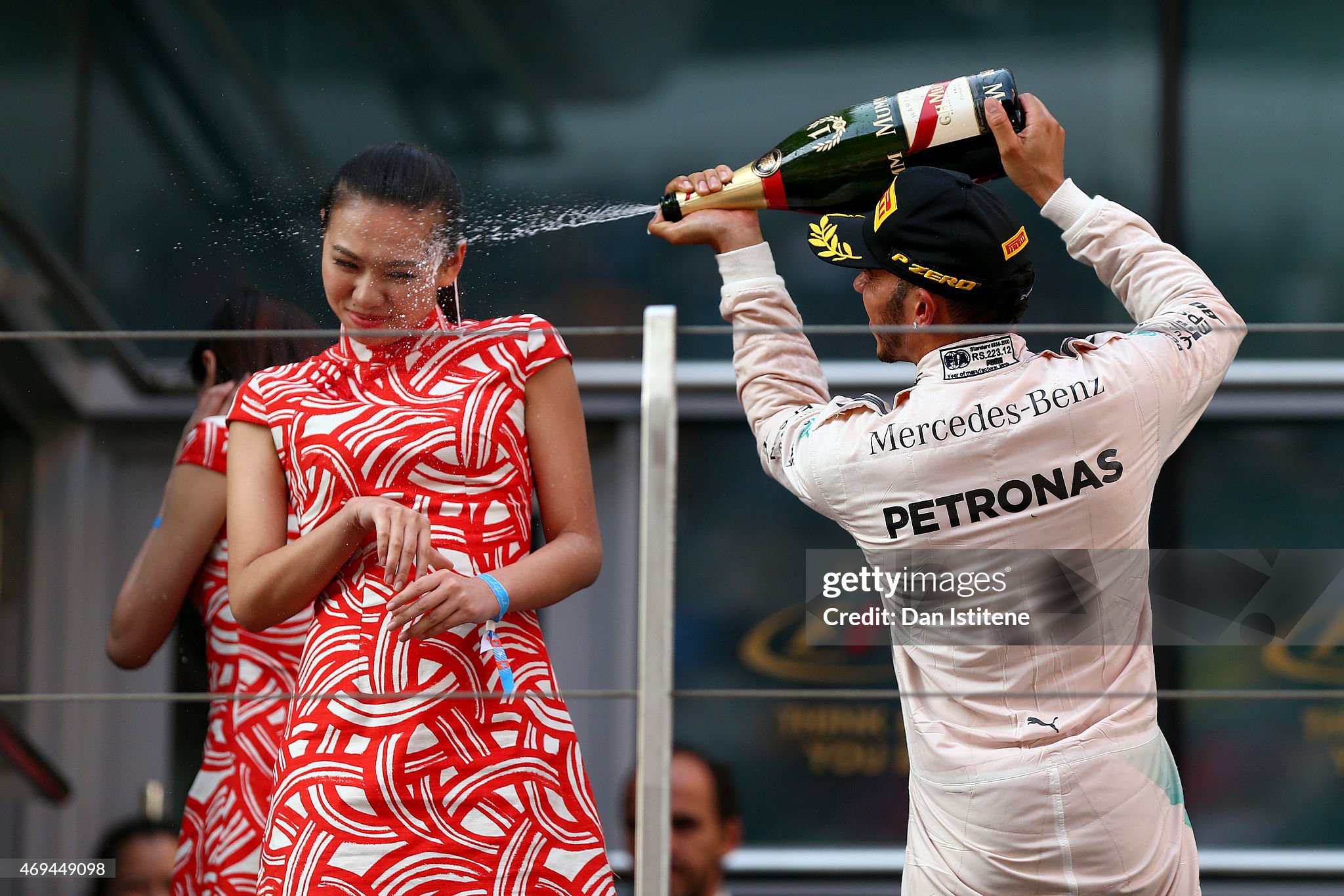 Liu Siying was pictured grimacing as Lewis Hamilton sprayed champagne at her face after winning the Chinese Grand Prix on Sunday 12 April 2015.