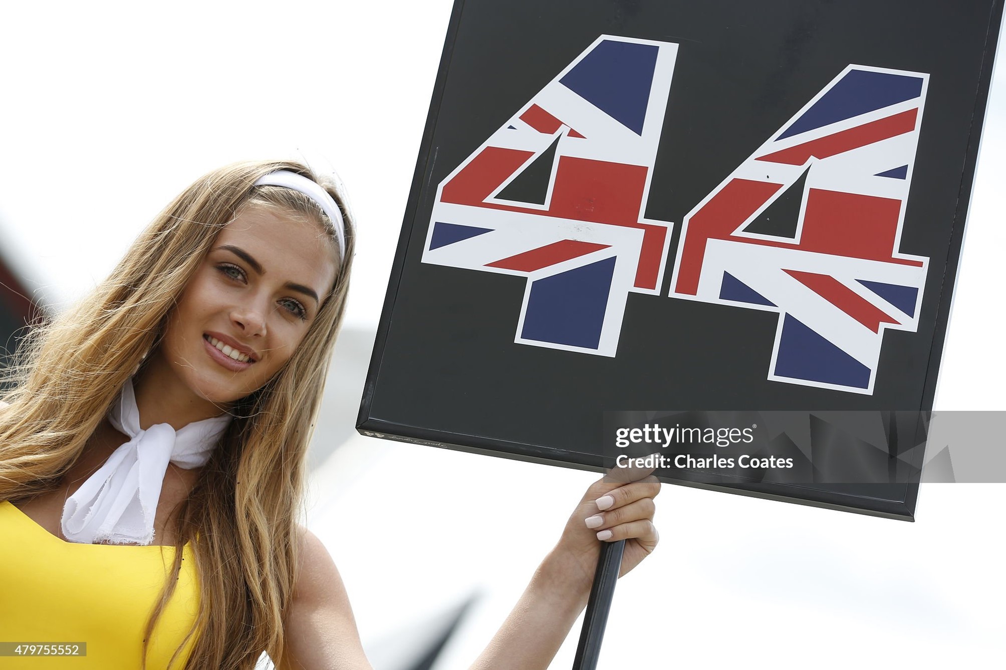 A grid girl poses with the race number of Lewis Hamilton before the Formula One Grand Prix of Great Britain at Silverstone Circuit on July 05, 2015. 