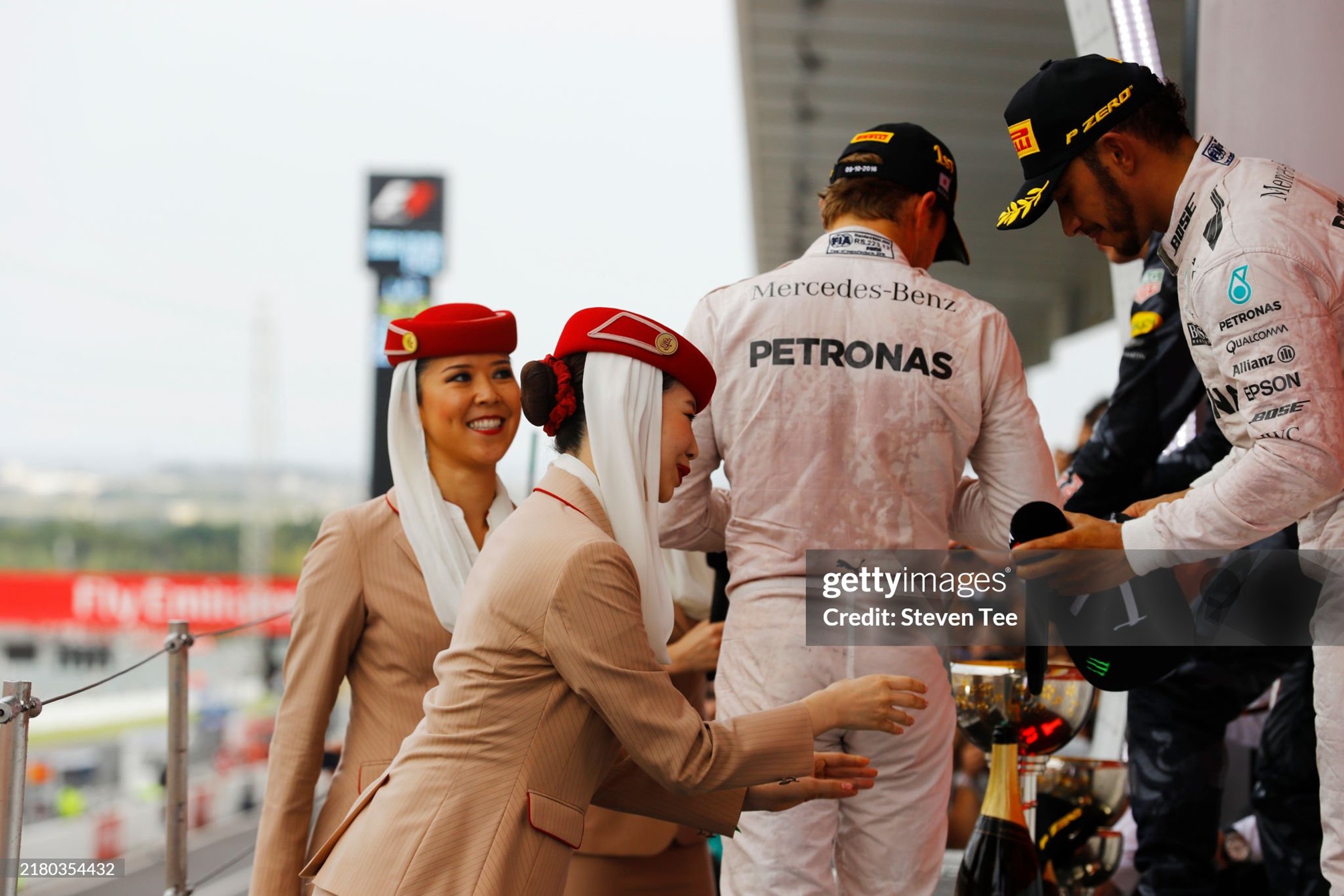 A grid girl hands a microphone to Lewis Hamilton, Mercedes AMG, 3rd position, on the podium at Suzuka Circuit, Japan, on Sunday 09 October 2016. 