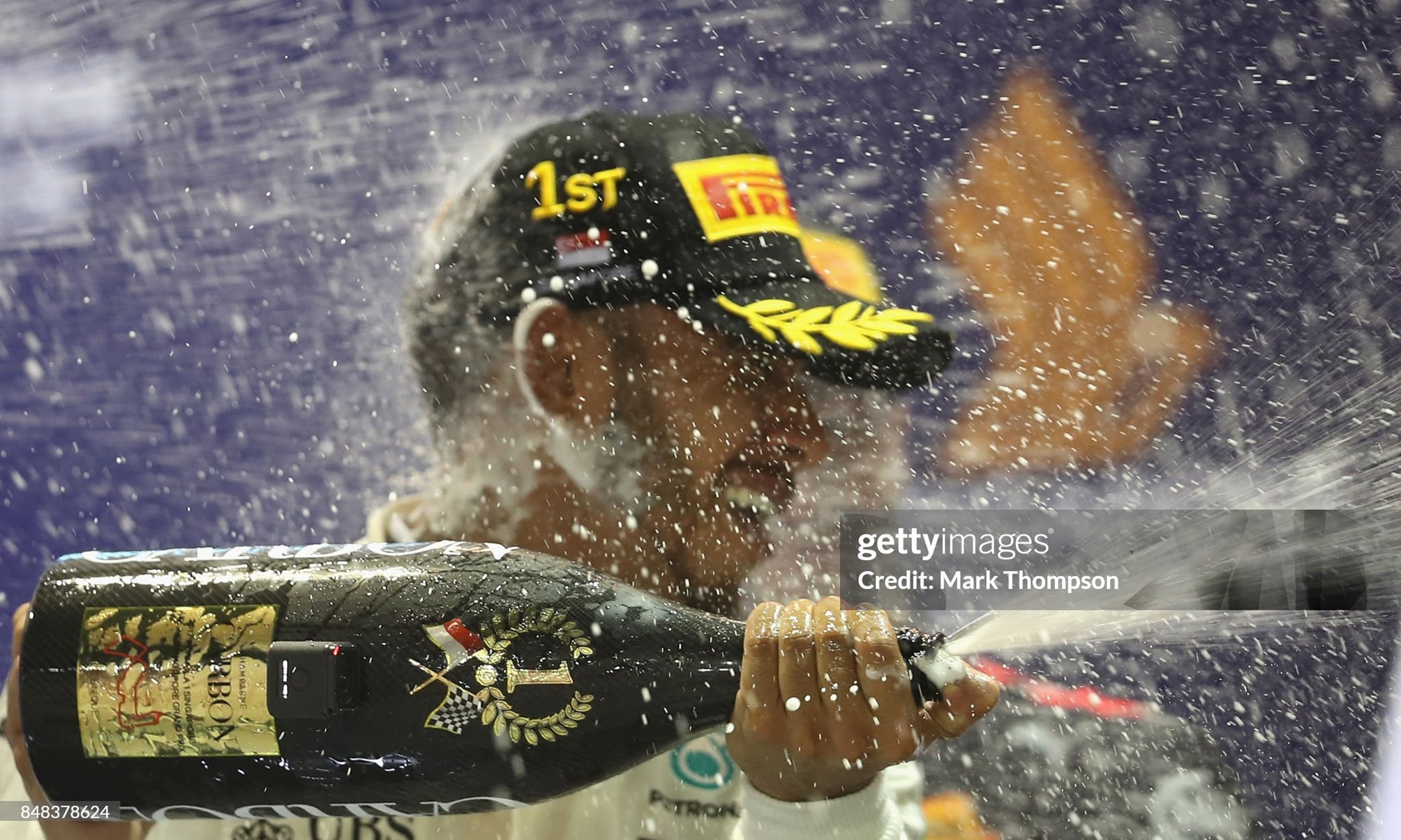 Race winner Lewis Hamilton celebrates on the podium after the Formula One Grand Prix of Singapore at Marina Bay Street Circuit on September 17, 2017. 