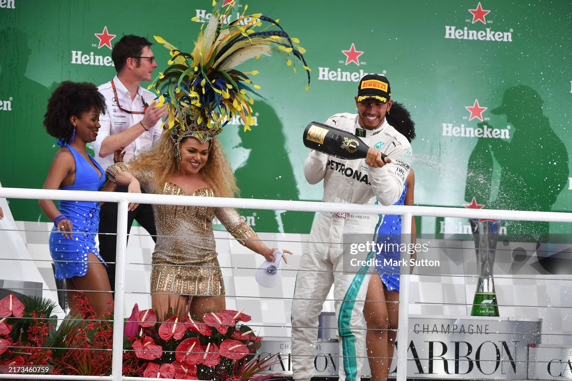 Race winner Lewis Hamilton celebrates on the podium with the samba girls and the champagne after the Brazilian Grand Prix at Autódromo José Carlos Pace on November 11, 2018. 