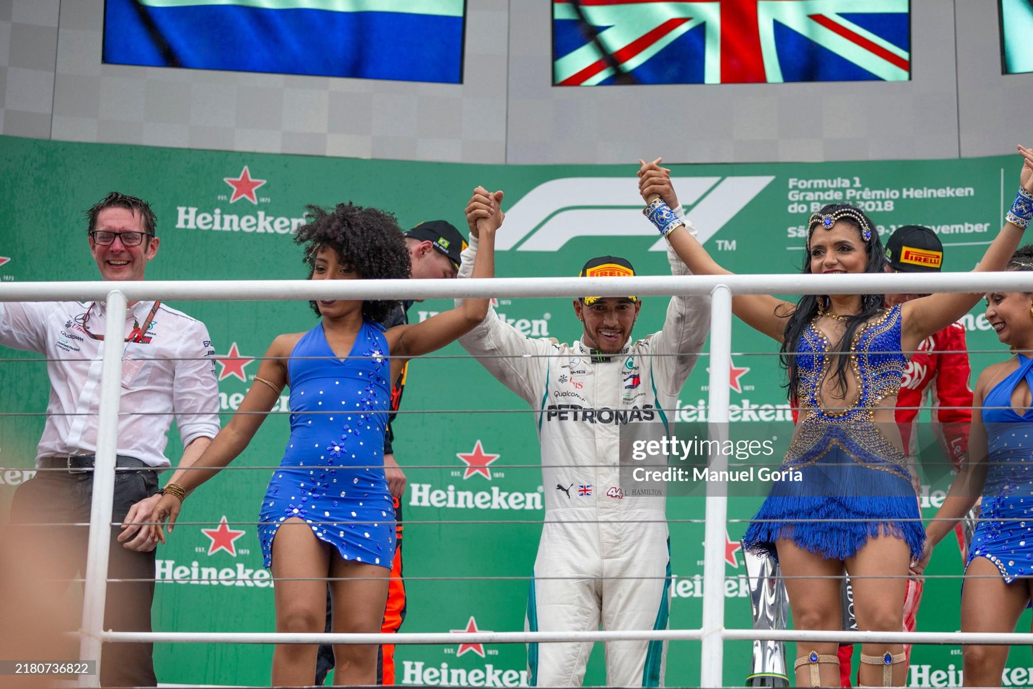 Race winner Lewis Hamilton celebrates on the podium with the samba girls after the Brazilian Grand Prix at Autódromo José Carlos Pace on November 11, 2018. 