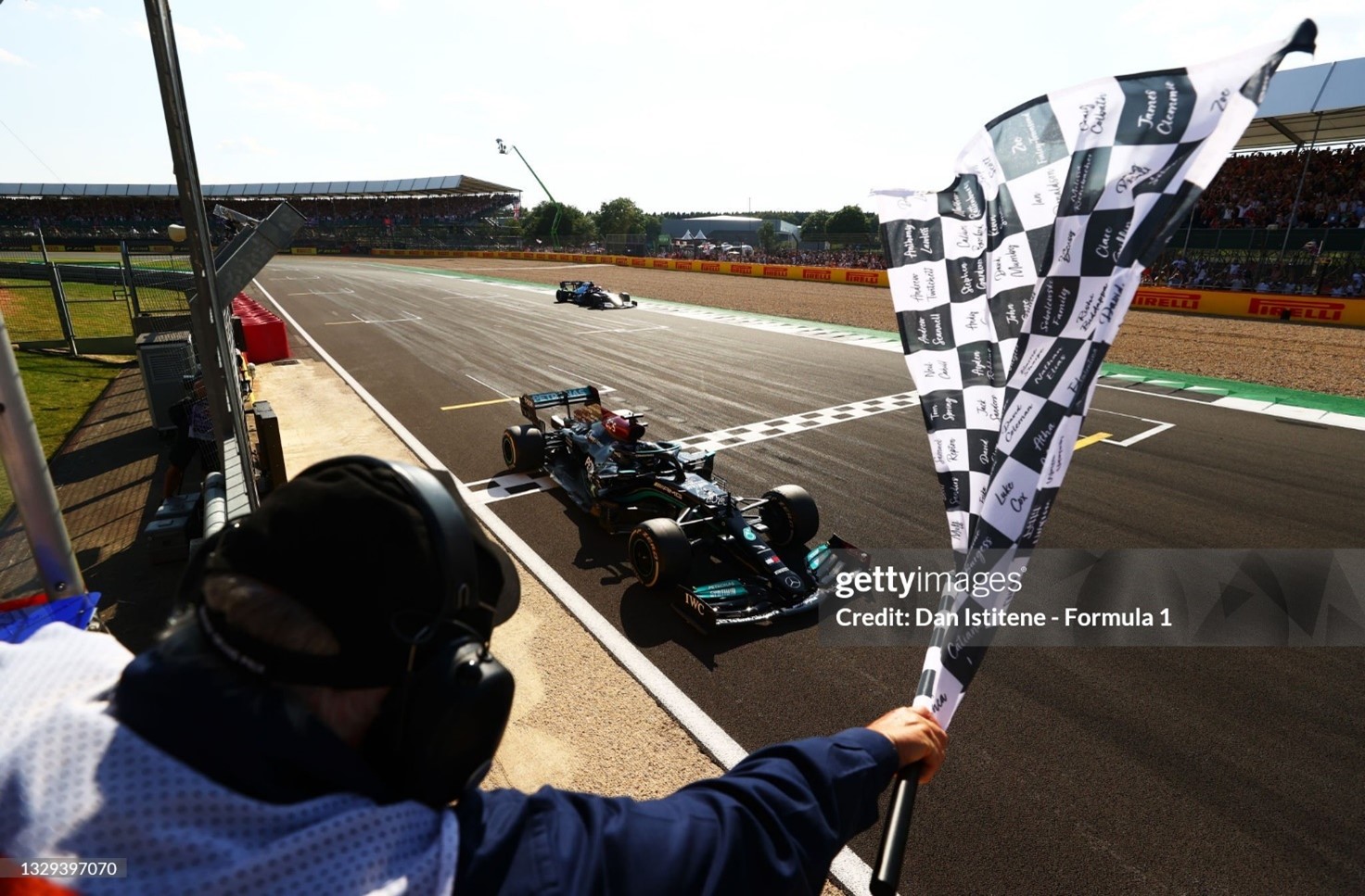 Race winner Lewis Hamilton takes the chequered flag after the F1 Grand Prix of Great Britain at Silverstone on July 18, 2021. 