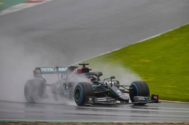 Lewis Hamilton driving his Mercedes in the rain.