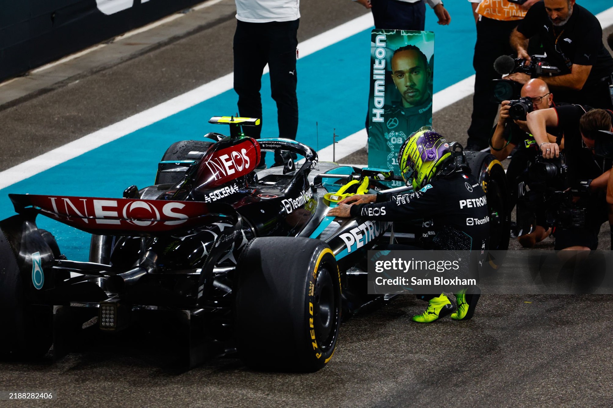 Lewis Hamilton bends down and gives his Mercedes one last hug after the F1 Grand Prix of Abu Dhabi at Yas Marina Circuit on 08 December 2024. 