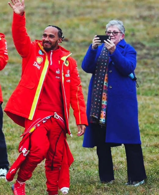 Lewis Hamilton's mother taking a picture of her son at his first test with Ferrari.