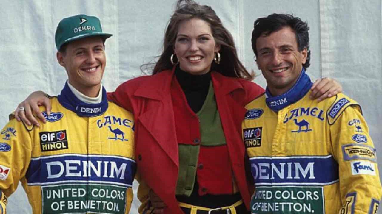 Michael Schumacher, Riccardo Patrese and a model of the team's main sponsor Benetton at the 1993 Portuguese Grand Prix.