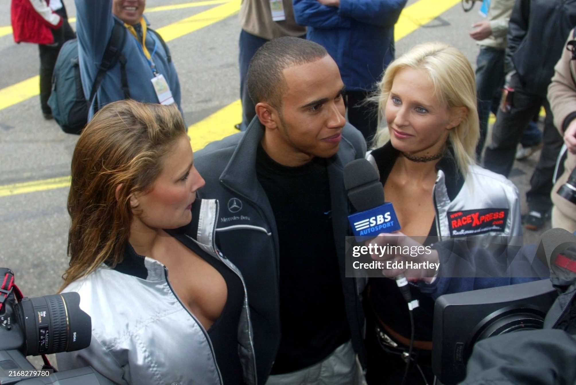 Lewis Hamilton, ASM F3 Dallara, is interviewed beside some large breasted women after taking pole at the Marlboro Masters of F3 in Zandvoort, Holland, on 10-12 June 2005. 