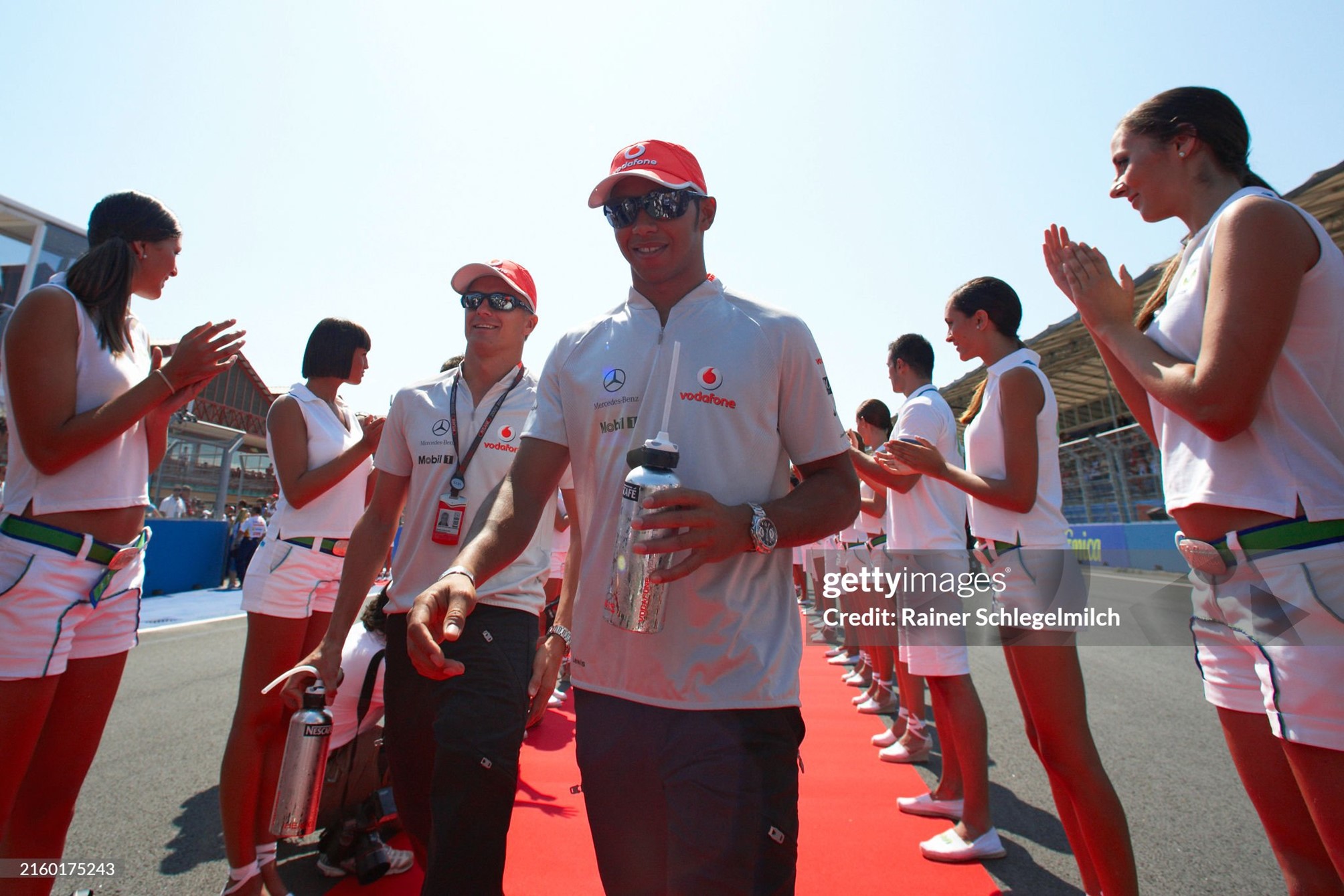 McLaren teammates Lewis Hamilton and Heikki Kovalainen walk to the drivers' parade during the European Grand Prix at Valencia Street Circuit on August 23, 2009. 