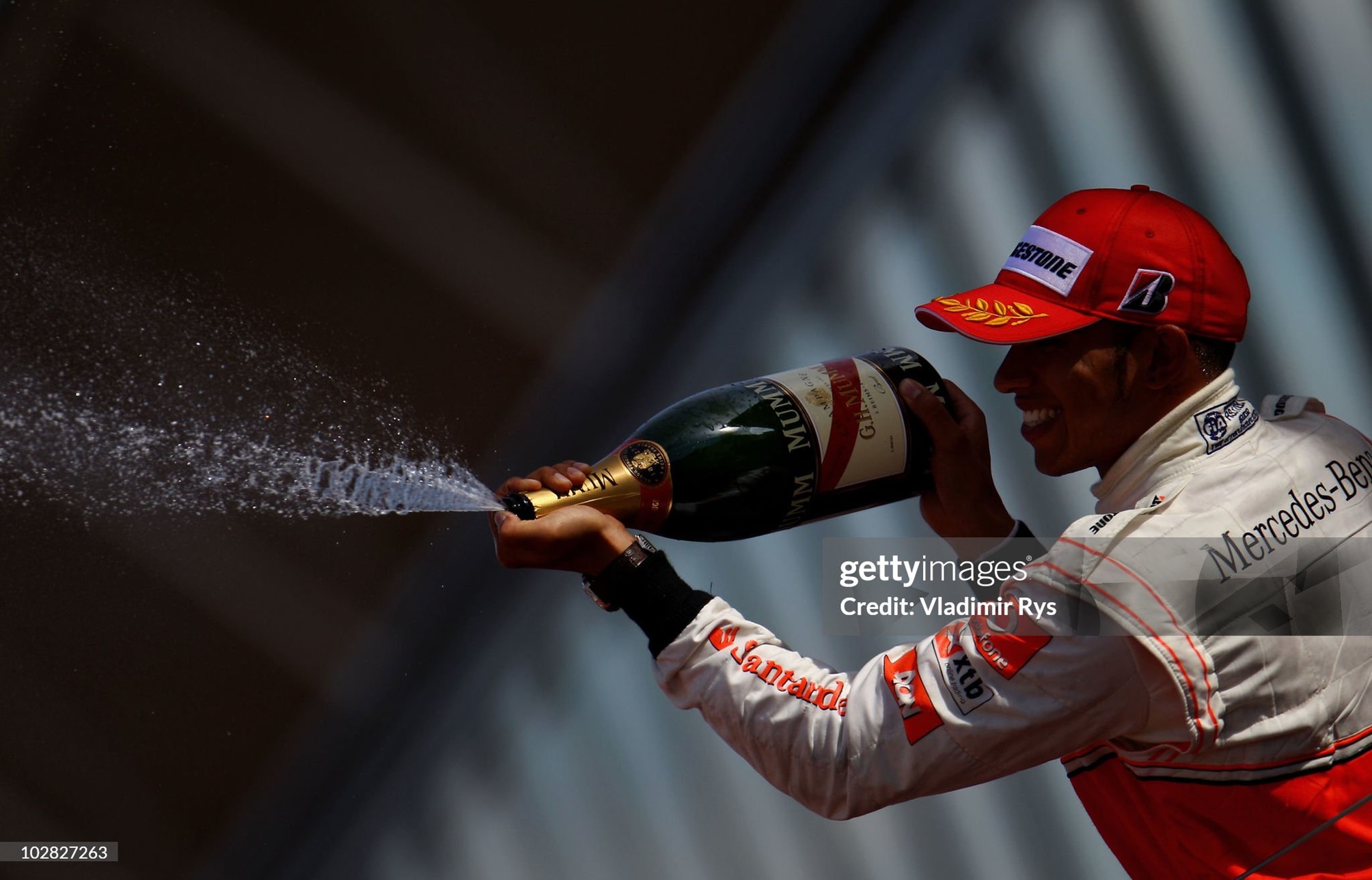 Lewis Hamilton celebrates on the podium after finishing second in the British Formula One Grand Prix at Silverstone in Northampton, England, on 11 June 2010. 