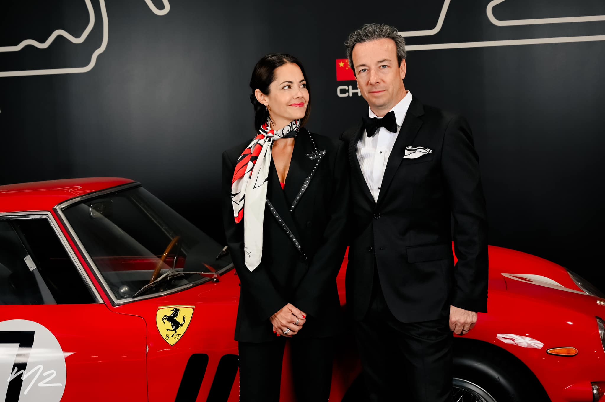 Luc Poirier with his wife Isabelle Gauvin and one of his beloved Ferraris.