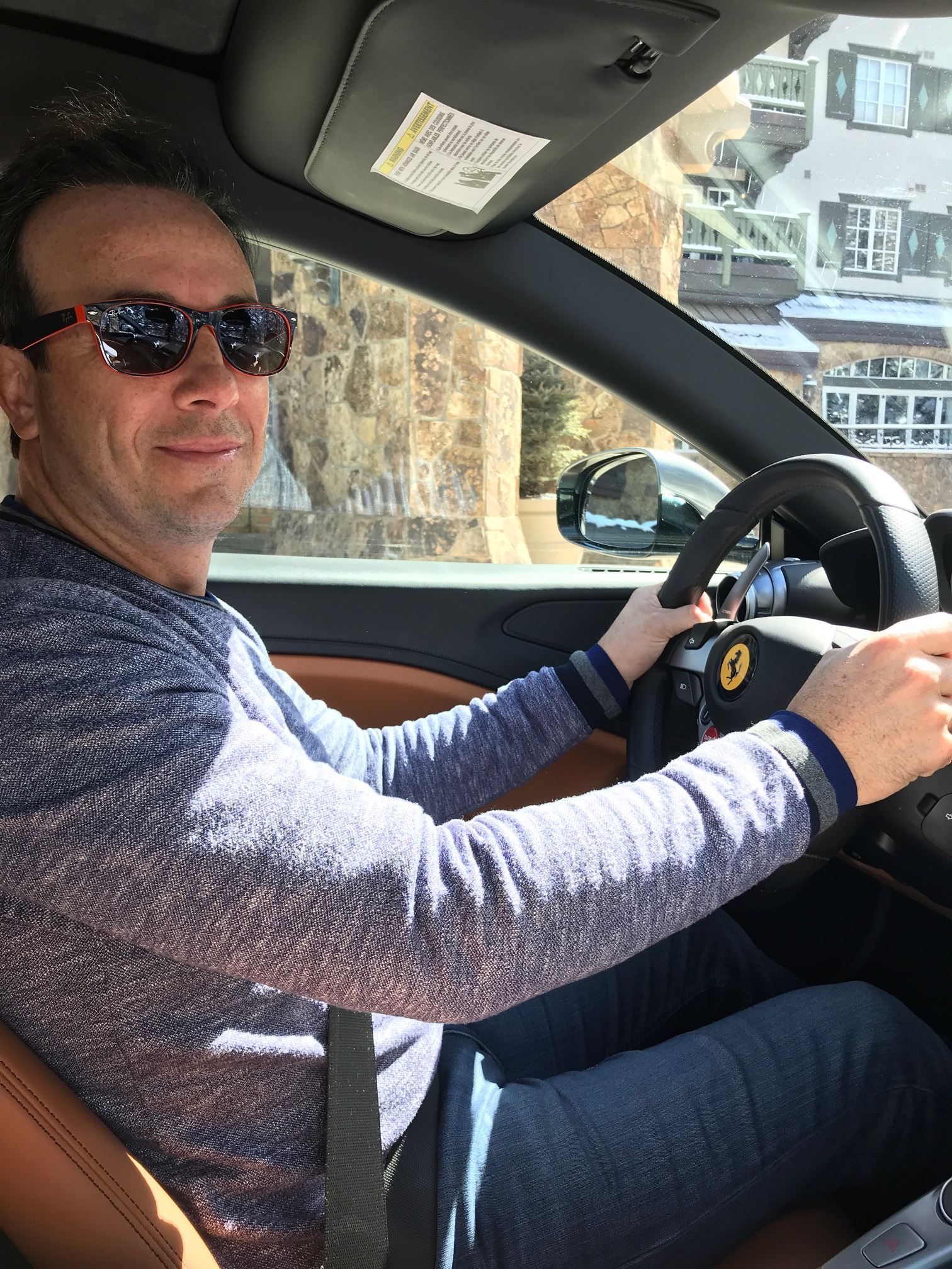 Luc Poirier driving a Ferrari.