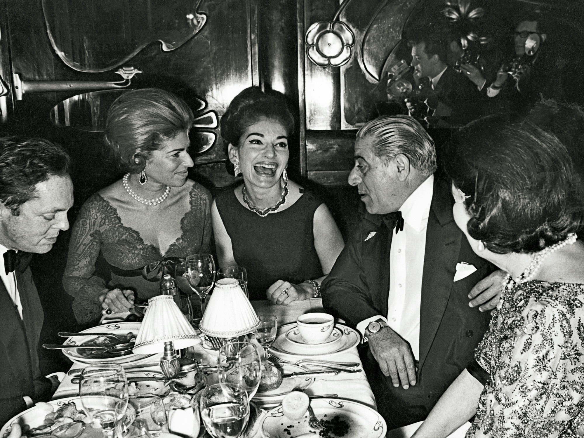 Maria Callas and Aristotle Onassis at their favorite table at restaurant Maxim's in Paris with Marie Helene de Rothschild and Alexis von Rosenberg, Baron de Redé.