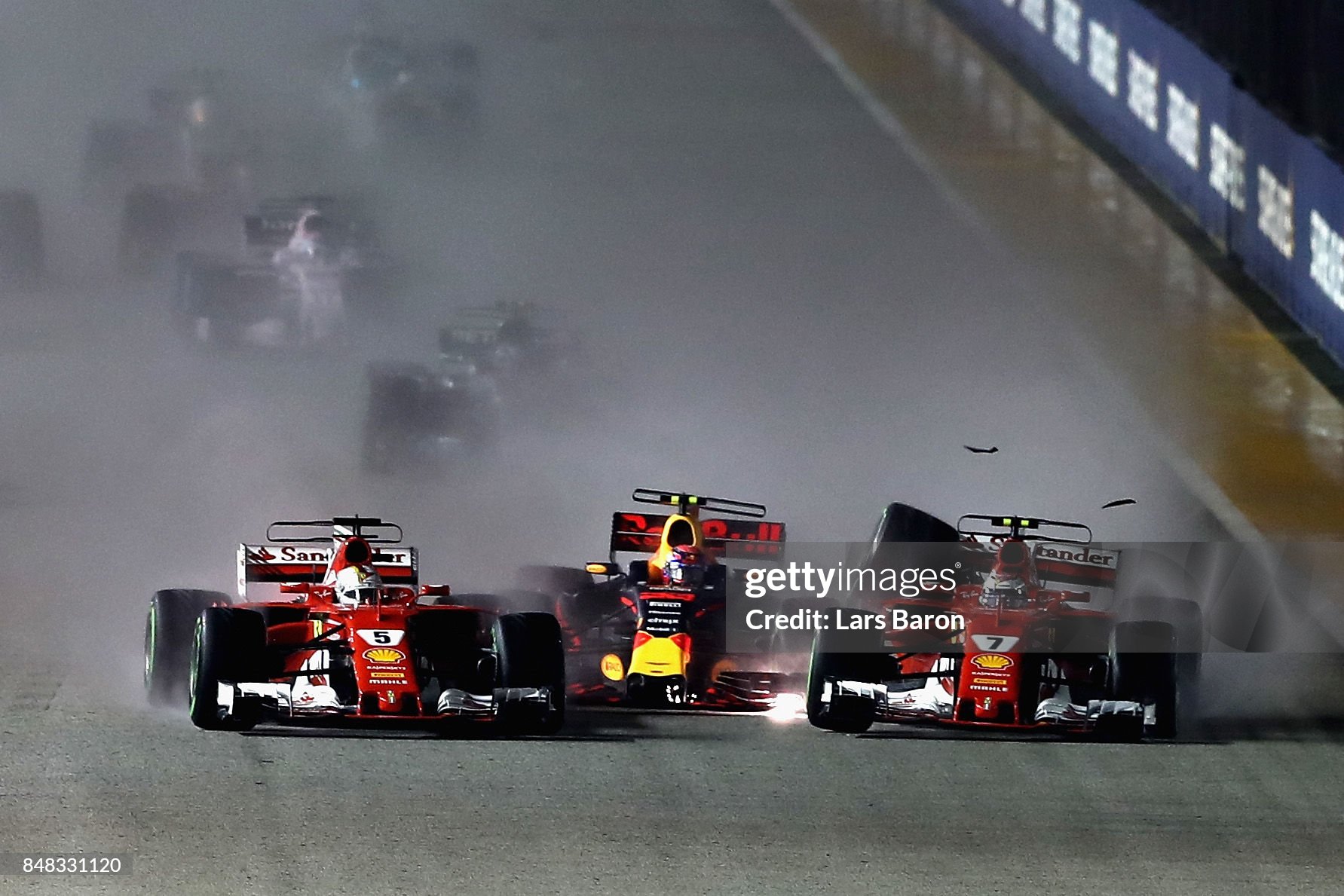 Sebastian Vettel driving the Ferrari SF70H, Max Verstappen driving the Red Bull RB13 and Kimi Raikkonen driving the Ferrari SF70H are caught up in a crash at the start of the Formula One Grand Prix of Singapore at Marina Bay Street Circuit on September 17, 2017. 