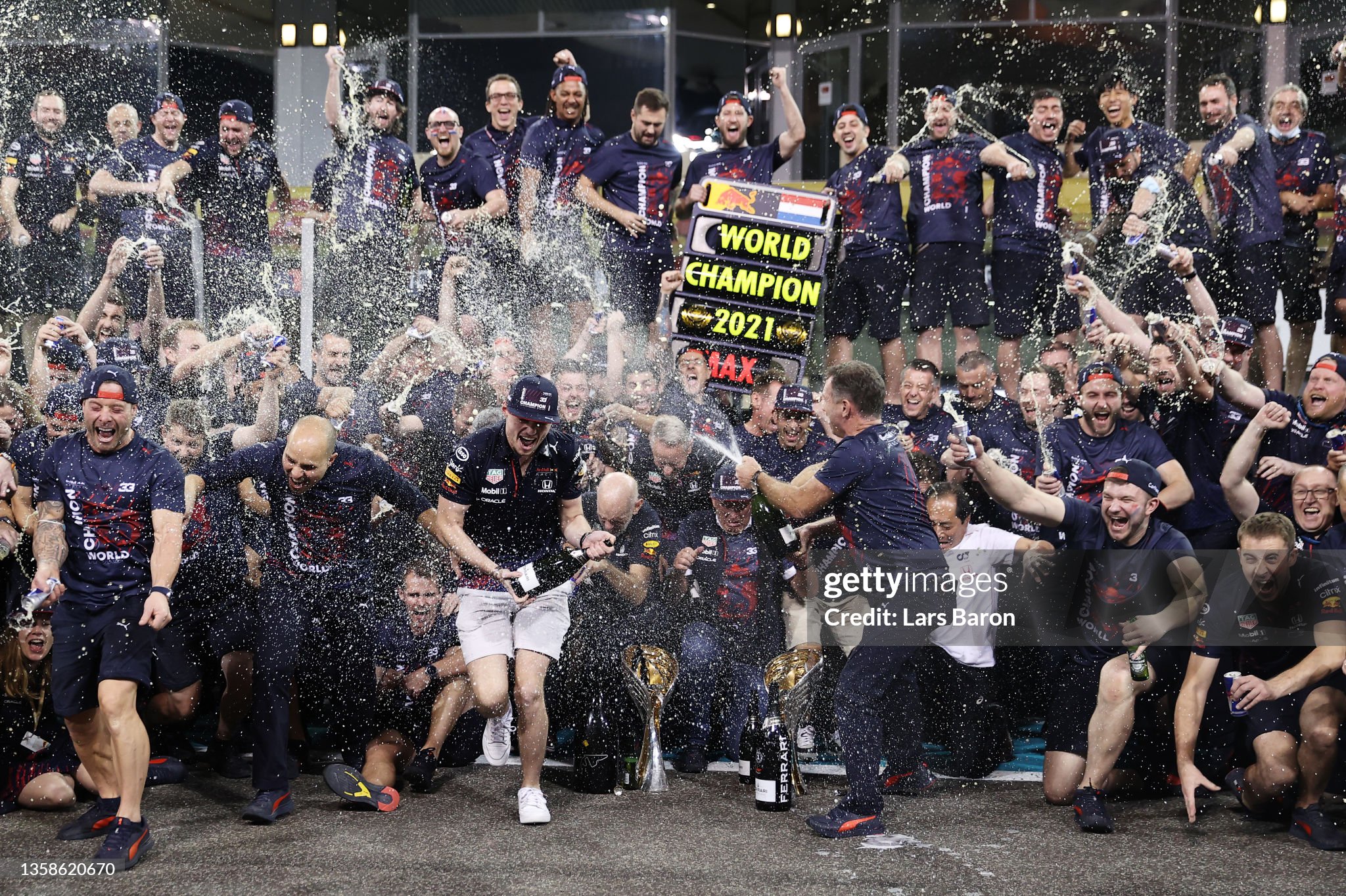 Race winner and 2021 F1 World Drivers Champion Max Verstappen celebrates with his team after the F1 Grand Prix of Abu Dhabi at Yas Marina Circuit on December 12, 2021. 