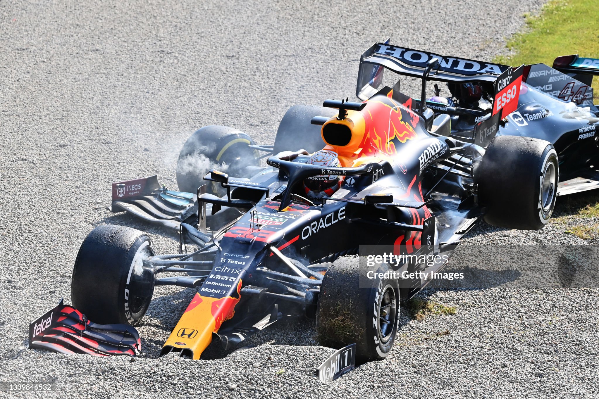 Max Verstappen driving the Red Bull RB16B Honda and Lewis Hamilton driving the Mercedes AMG W12 crash during the F1 Grand Prix of Italy at Autodromo di Monza on September 12, 2021.