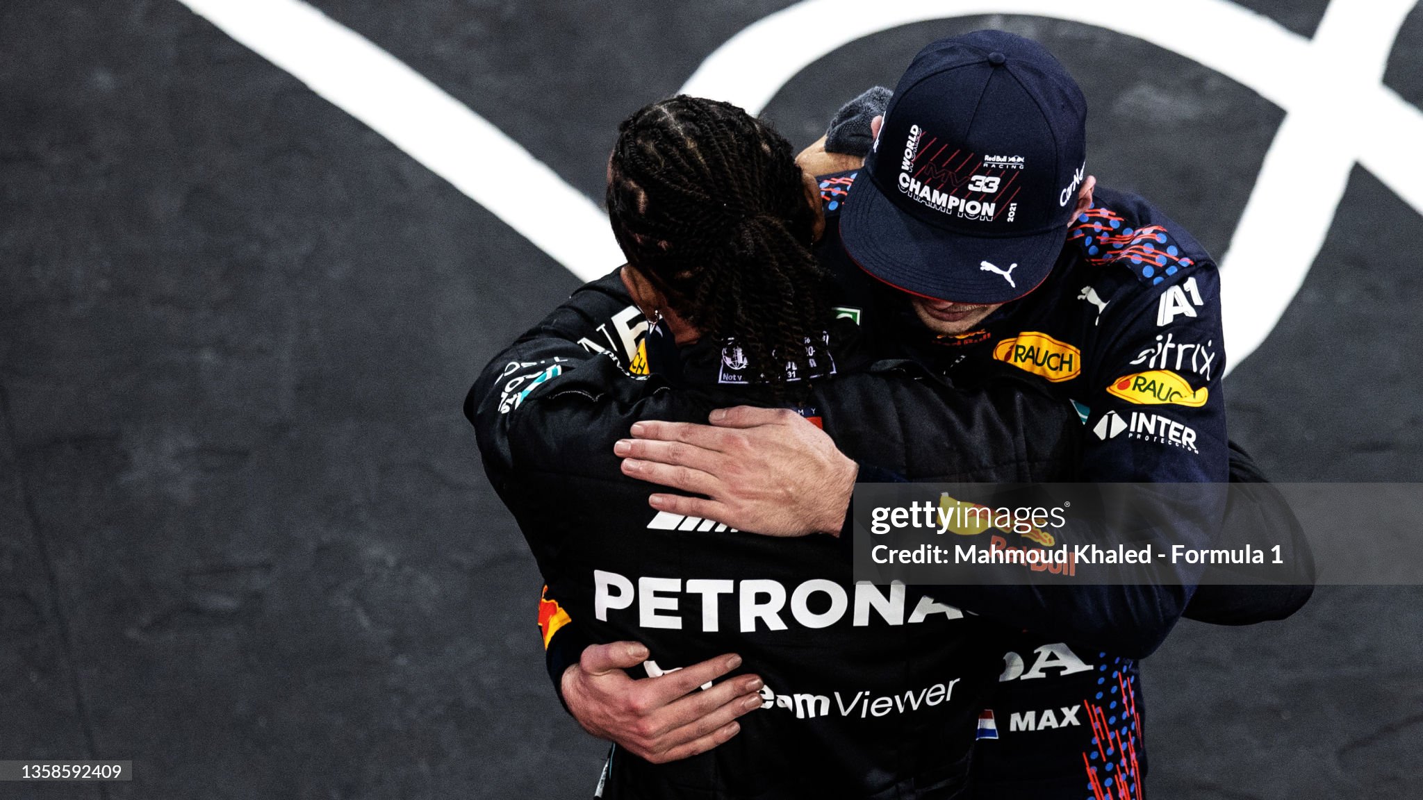 Race winner and 2021 F1 World Drivers Champion Max Verstappen of the Netherlands and Red Bull Racing is congratulated by runner up in the race and championship Lewis Hamilton of Great Britain and Mercedes during the F1 Grand Prix of Abu Dhabi at Yas Marina Circuit on December 12, 2021 in Abu Dhabi, United Arab Emirates. 