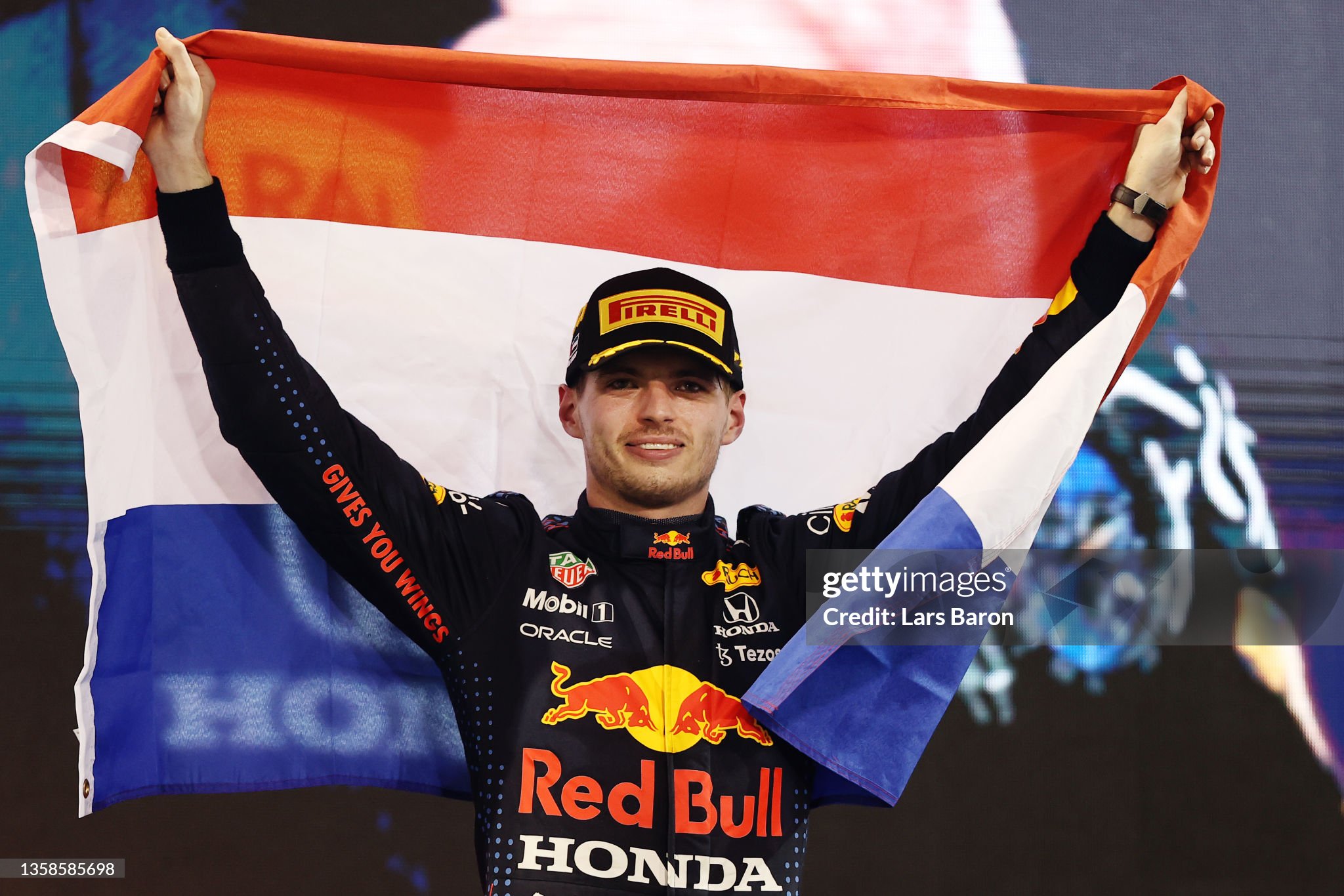 Race winner and 2021 F1 World Drivers Champion Max Verstappen celebrates on the podium after the F1 Grand Prix of Abu Dhabi at Yas Marina Circuit on December 12, 2021 in Abu Dhabi, United Arab Emirates. 