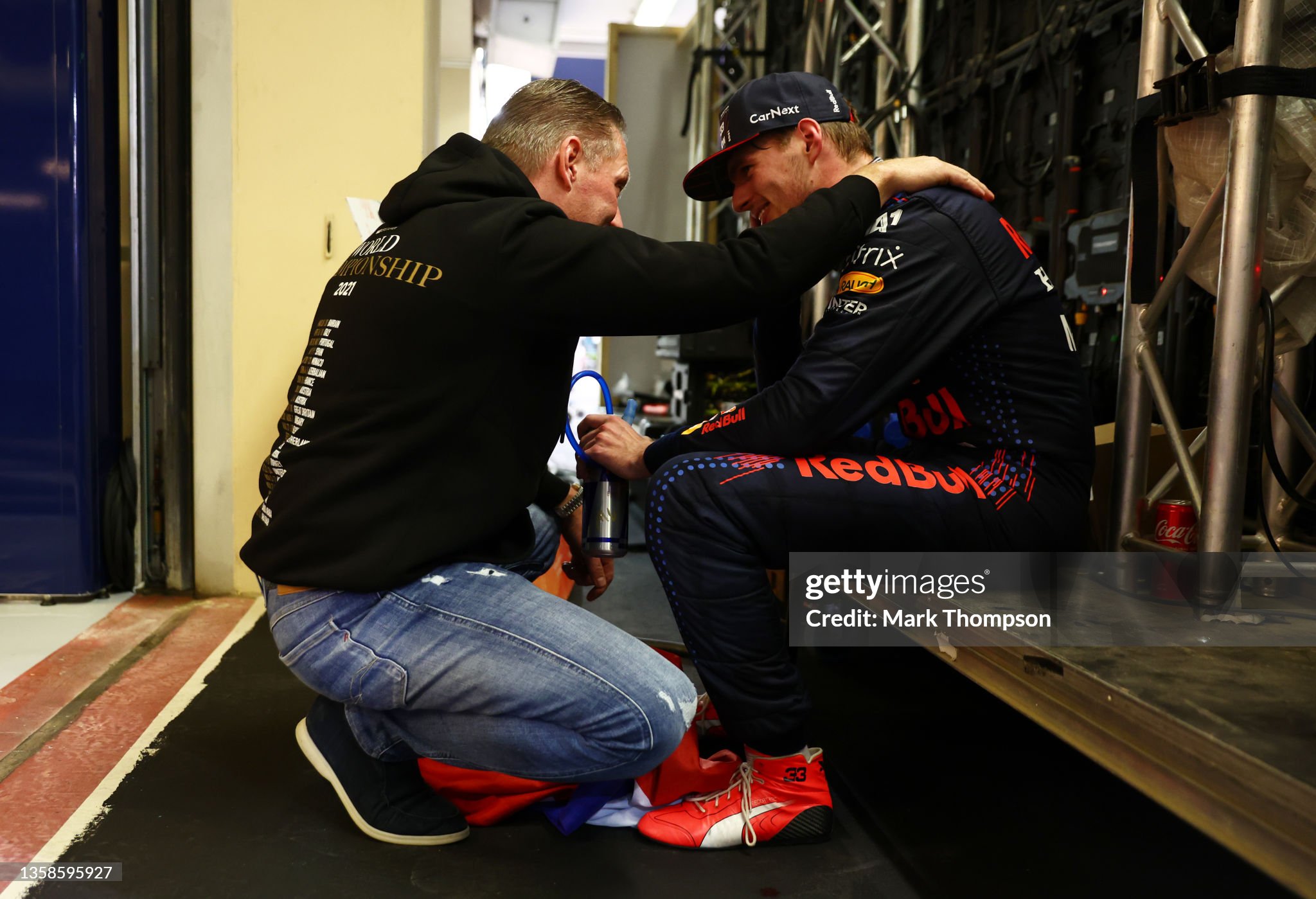 Race winner and 2021 F1 World Drivers Champion Max Verstappen celebrates with his father Jos Verstappen in parc ferme after the F1 Grand Prix of Abu Dhabi at Yas Marina Circuit on December 12, 2021. 