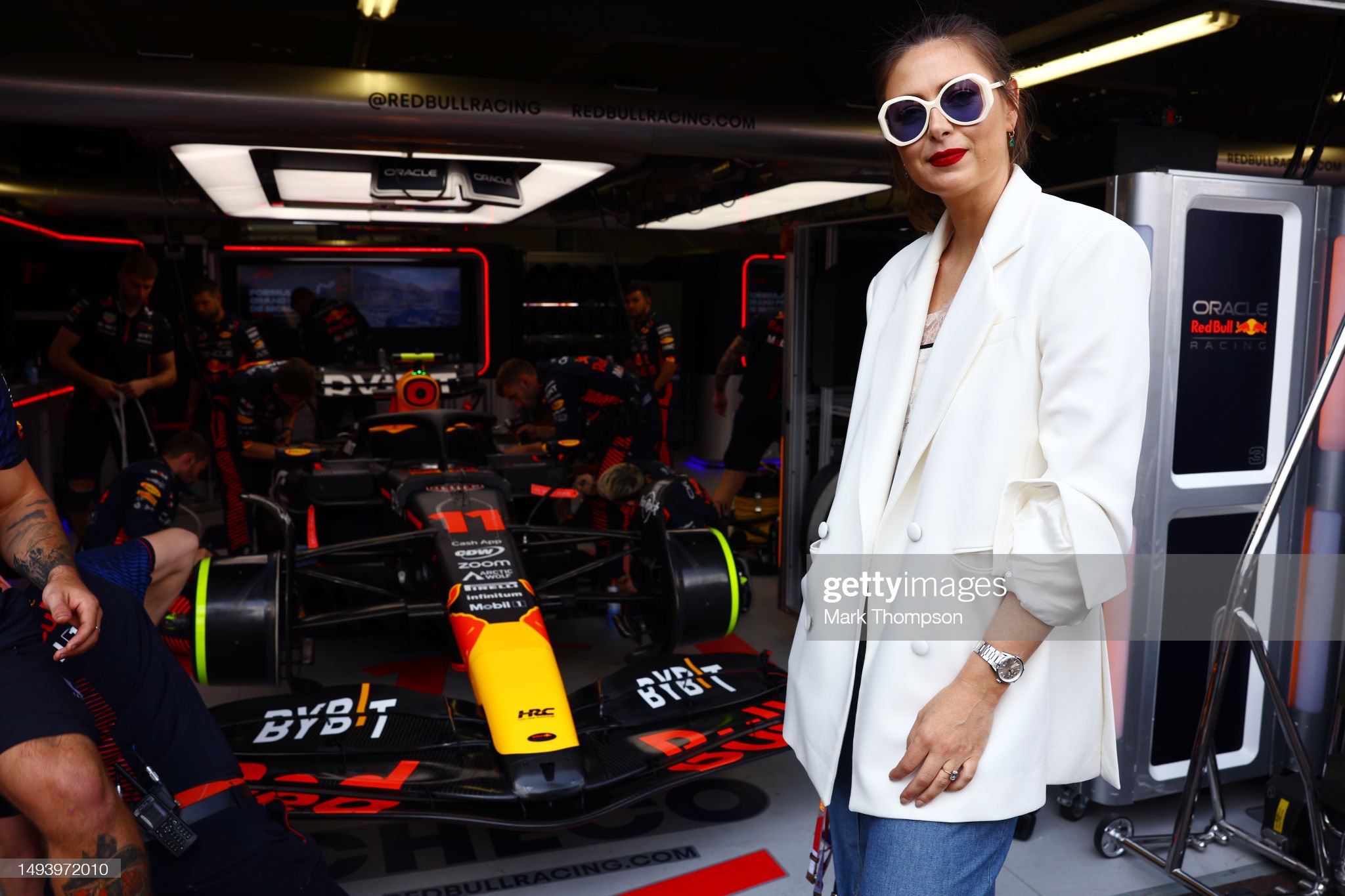 Maria Sharapova poses for a photo next to the car of Sergio Perez of Mexico and Red Bull in the garage during the F1 Grand Prix of Monaco at Circuit de Monaco on May 28, 2023. 