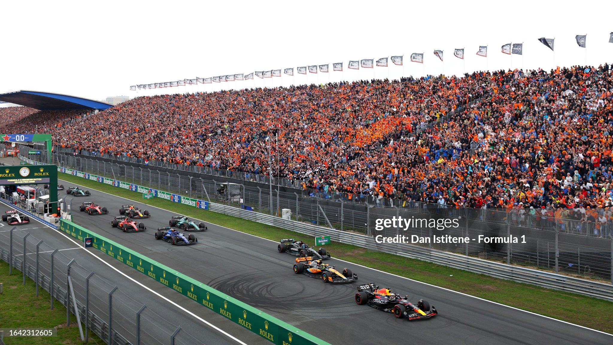 Max Verstappen leads Lando Norris driving the McLaren MCL60 Mercedes and the rest of the field at the start of the F1 Grand Prix of the Netherlands at Zandvoort on August 27, 2023. 