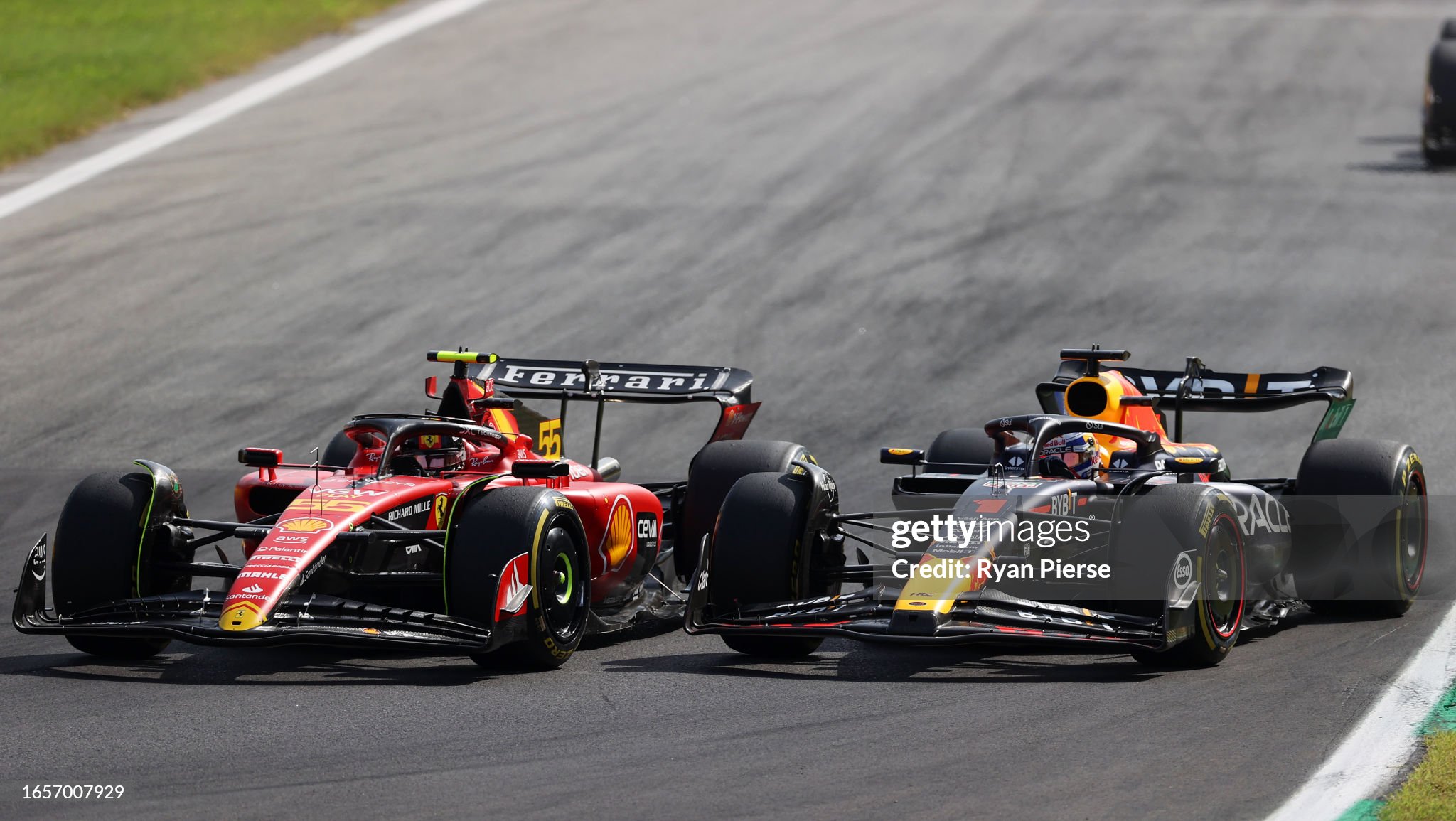 Carlos Sainz driving the Ferrari SF-23 and Max Verstappen driving the Red Bull RB19 battle for track position during the F1 Grand Prix of Italy at Autodromo Nazionale Monza on September 03, 2023. 