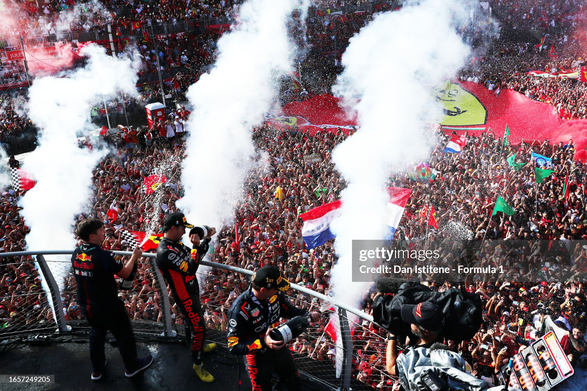 Race winner Max Verstappen and second placed Sergio Perez celebrate on the podium after the F1 Grand Prix of Italy at Autodromo Nazionale Monza on September 03, 2023.