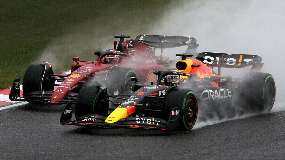 Max Verstappen wheel to wheel with Charles Leclerc in the rain.