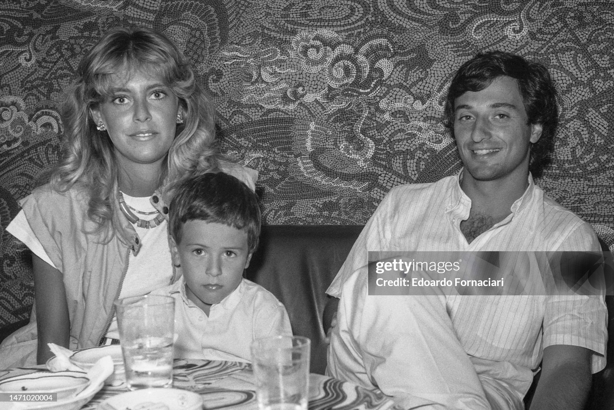 Susi Martinis and Italian Formula One driver Riccardo Patrese with their son Simone at the Excelsior Hotel bar during the Venice Film Festival on August 30, 1982. 