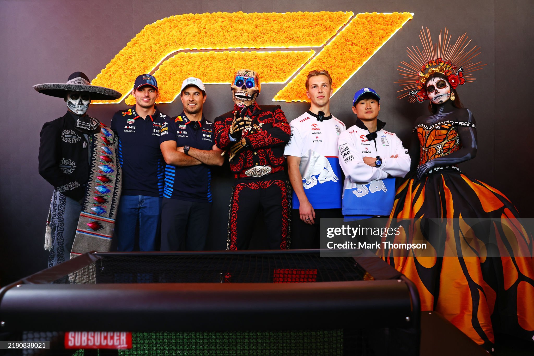 Max Verstappen, Sergio Perez, Liam Lawson and Yuki Tsunoda pose for a photo with Day of the Dead performers in the paddock during previews ahead of the F1 Grand Prix of Mexico at Autodromo Hermanos Rodriguez on 24 October 2024 in Mexico City, Mexico. 