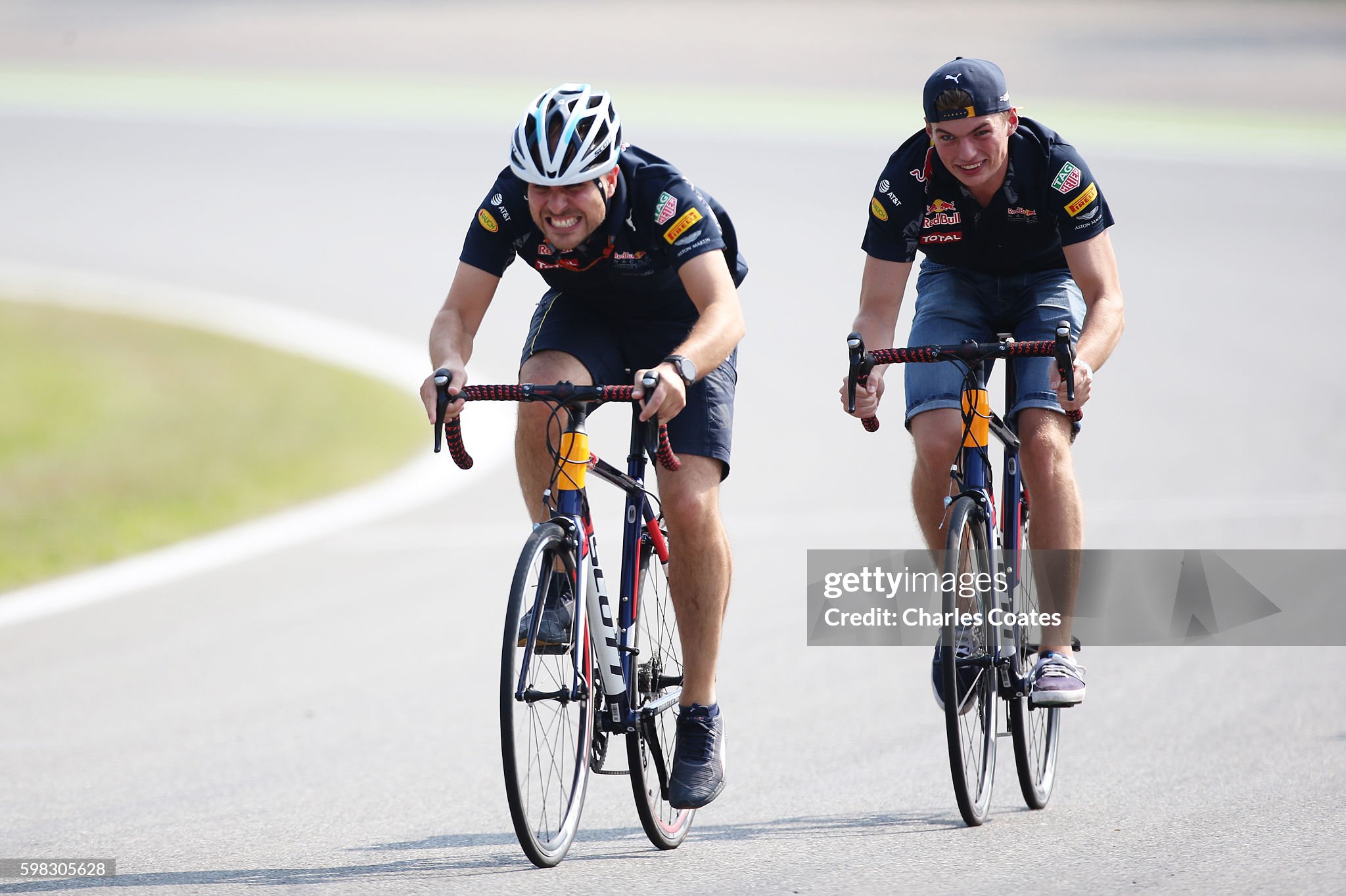 Max Verstappen rides a bicycle with race engineer Gianpiero Lambiase on the track during previews for the Formula One Grand Prix of Italy at Autodromo di Monza on 01 September 2016 in Monza, Italy. 