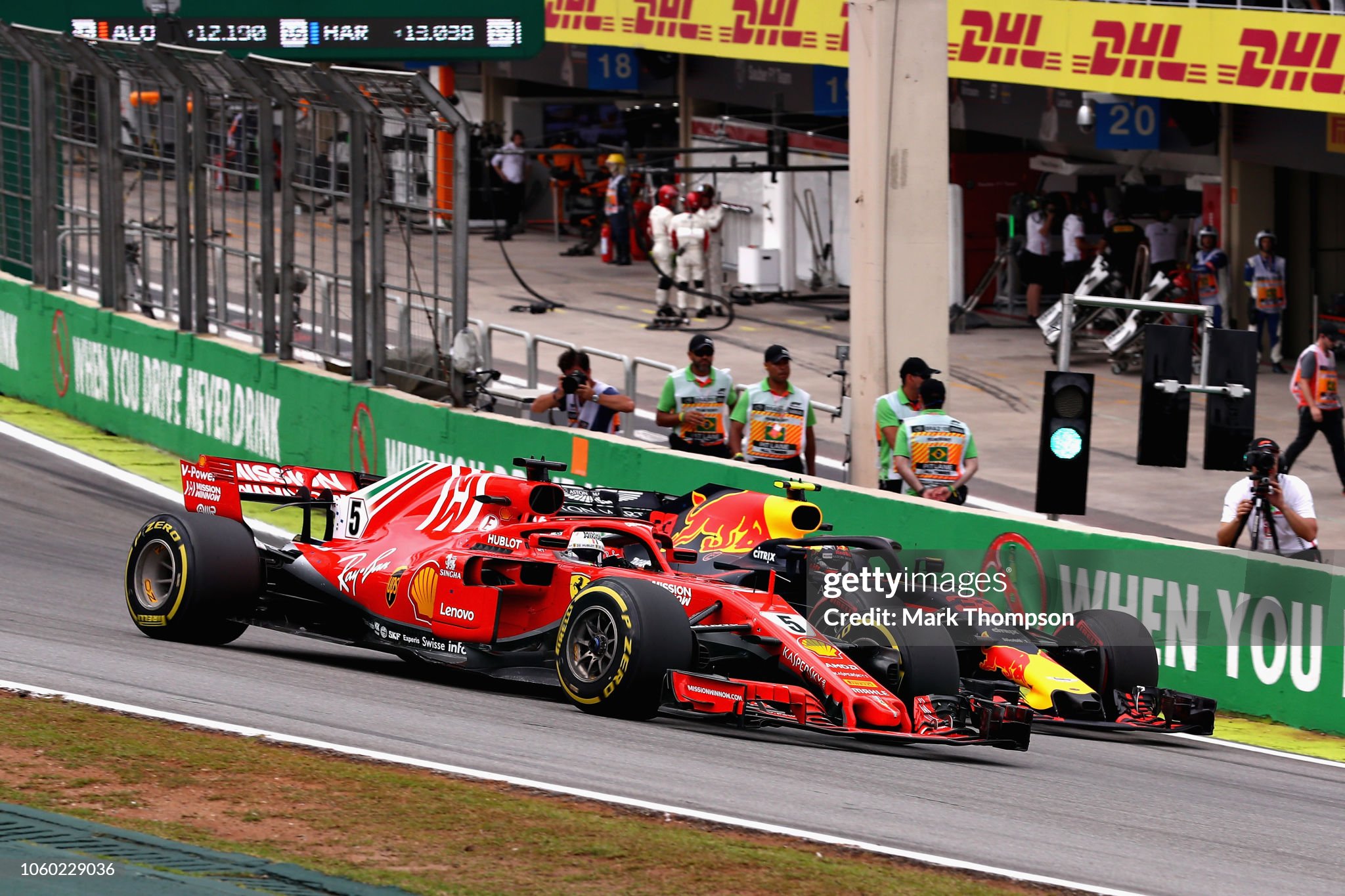 Max Verstappen driving the Red Bull Racing RB14 overtakes Kimi Raikkonen driving the Ferrari SF71H and Sebastian Vettel driving the Ferrari SF71H on track during the Formula One Grand Prix of Brazil at Autodromo Jose Carlos Pace on 11 November 2018 in Sao Paulo, Brazil. 