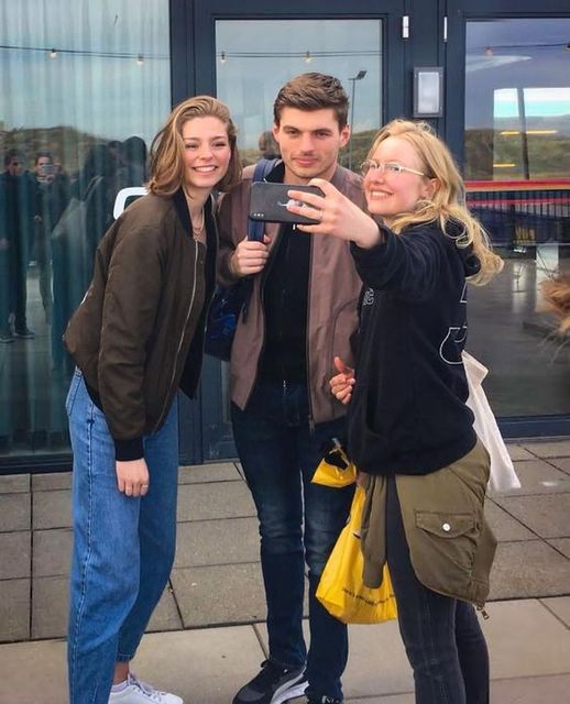 Max Verstappen stops for a selfie with some female fans.