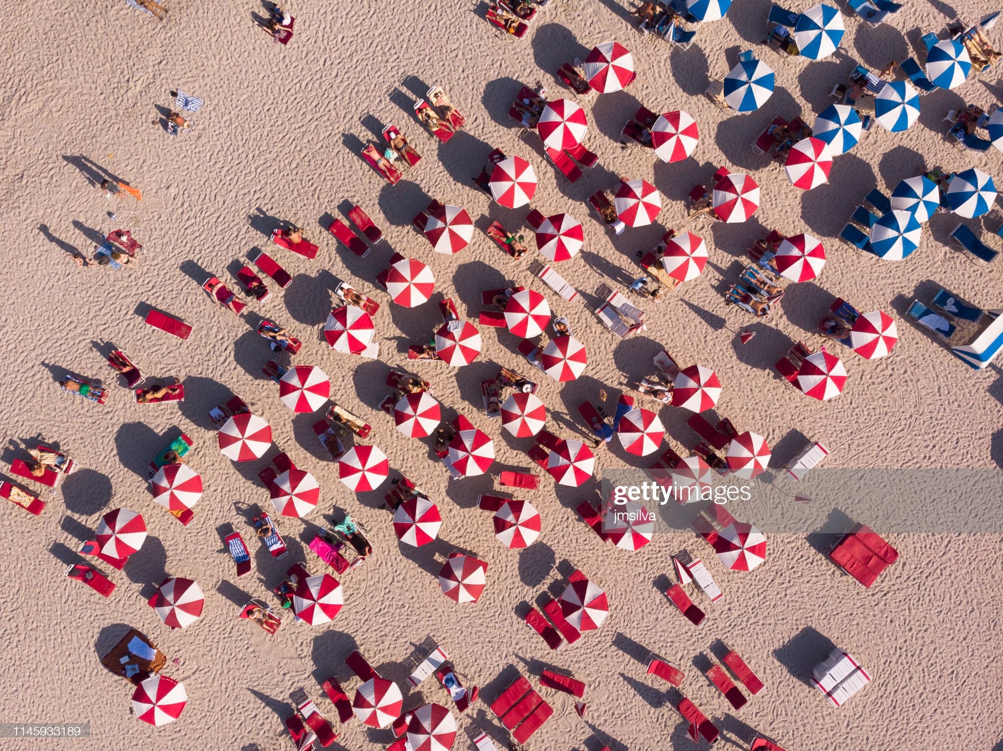 Crowd sunbathing on the beach, South Beach, Florida, USA. 