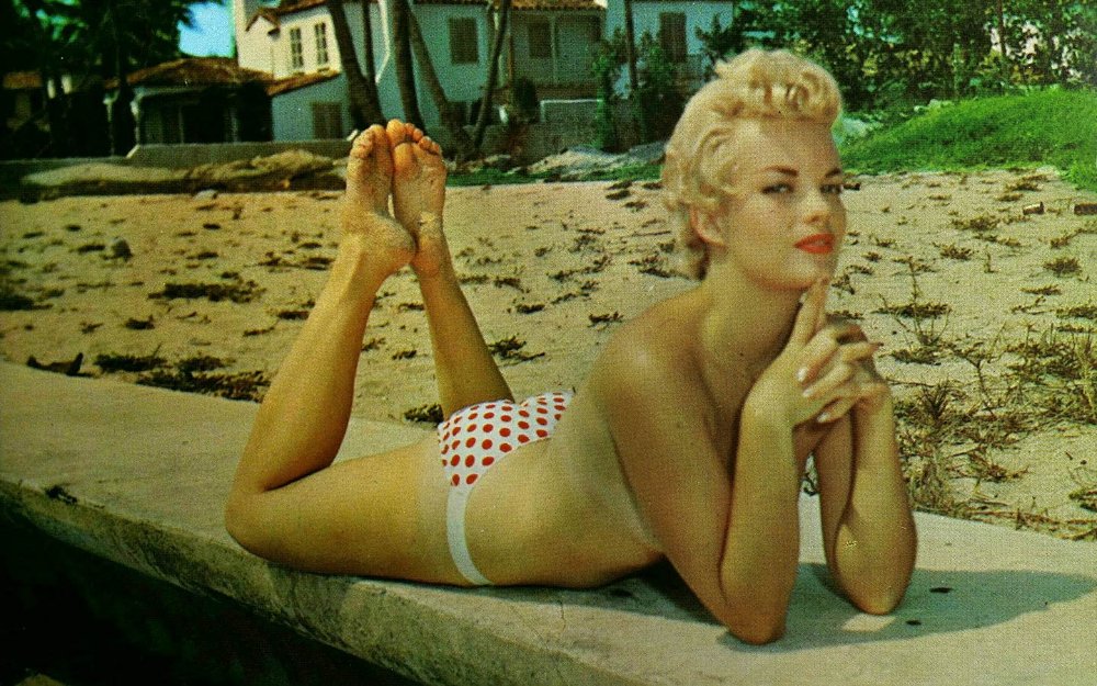 Vintage Miami Beach postcard of a cheesecake blonde.