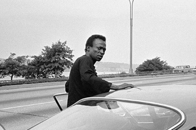 Miles Davis getting ready to drive his Ferrari 275 GTB.