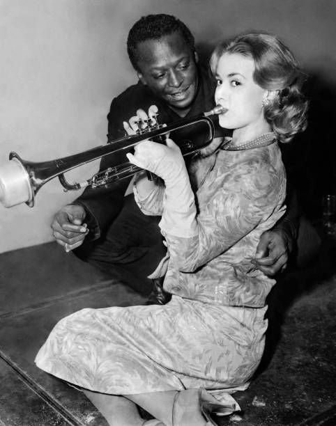 US trumpet player Miles Davis gives a lesson to French actress Jeanne Moreau in Paris on 05 December 1957.