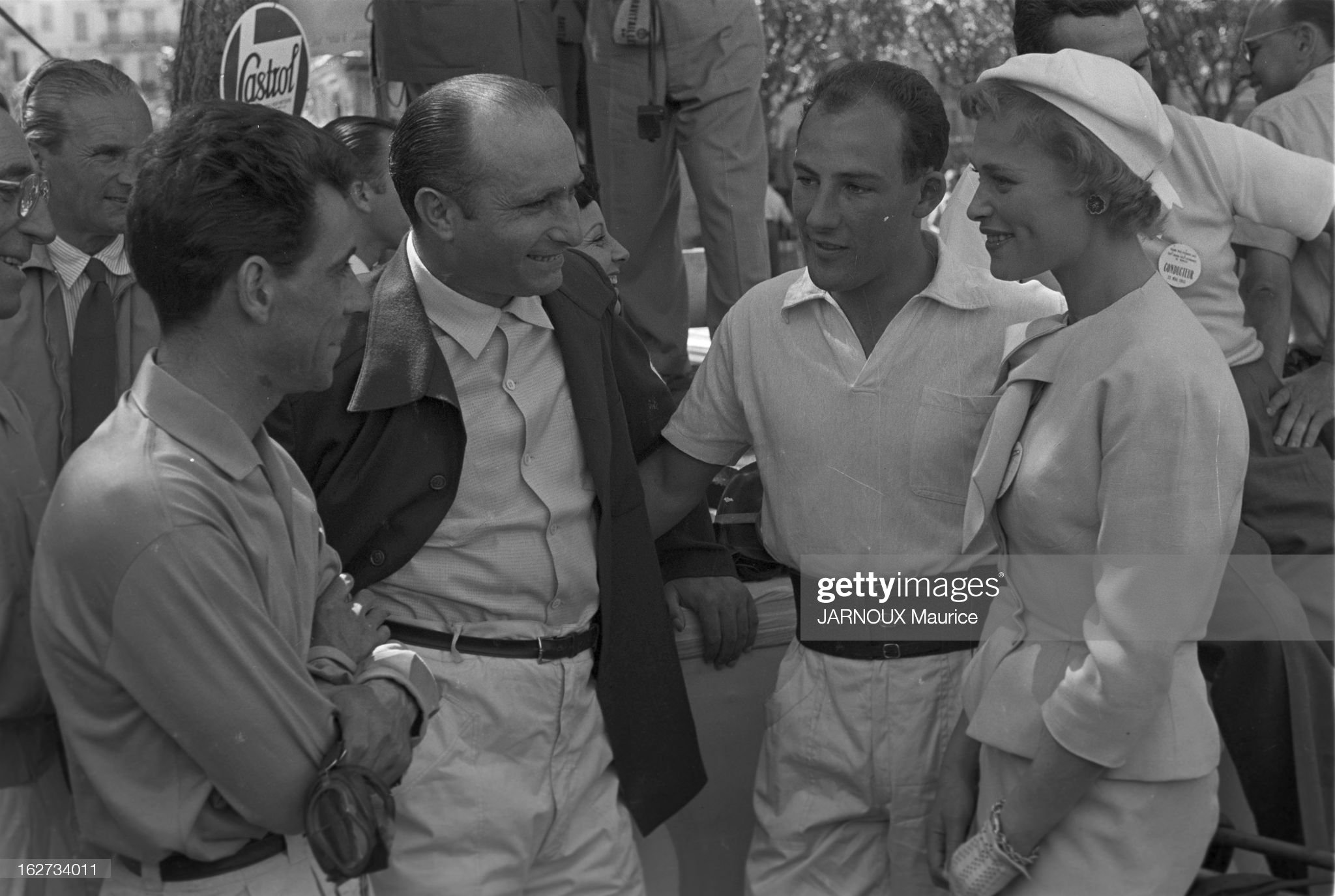 The Monaco Grand Prix 1955. Stirling Moss, Juan Manuel Fangio and a girl.