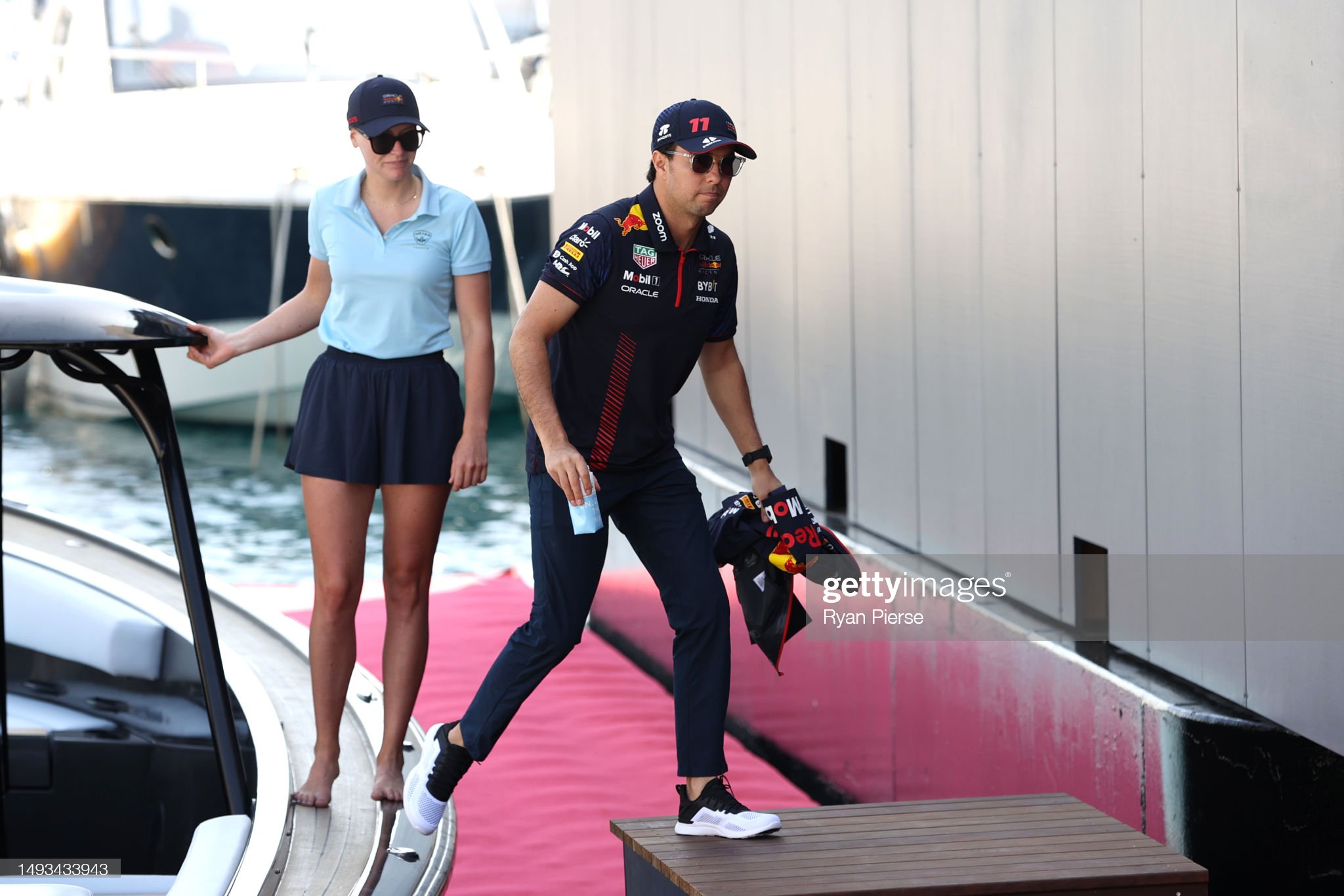 Sergio Perez of Red Bull Racing arrives in the paddock with a girl prior to practice ahead of the F1 Grand Prix of Monaco at Circuit de Monaco on May 26, 2023.