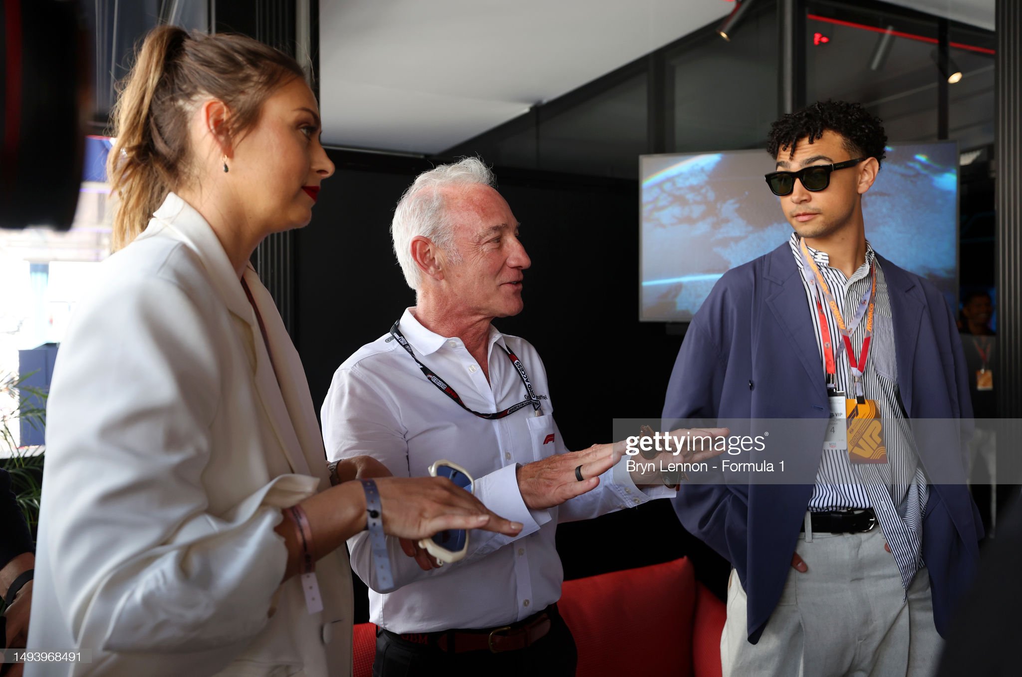 Greg Maffei, CEO of Liberty Media and Archie Madekwe talk in the paddock at Circuit de Monaco on May 28, 2023 in Monte-Carlo, Monaco. 