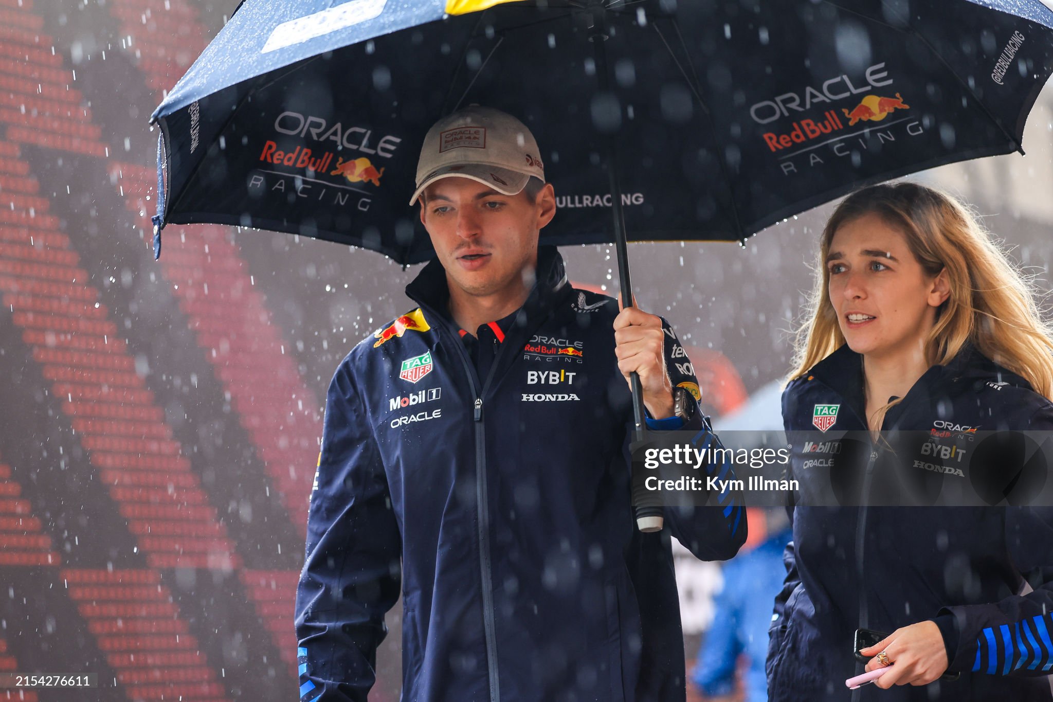 Max Verstappen walks in the paddock under an umbrella during previews ahead of the F1 Grand Prix of Monaco at Circuit de Monaco on May 23, 2024. 