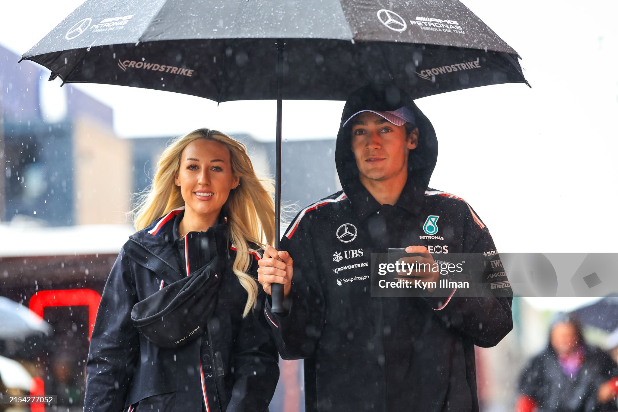 George Russell of Great Britain and Mercedes walks under an umbrella during previews ahead of the F1 Grand Prix of Monaco on May 23, 2024. 