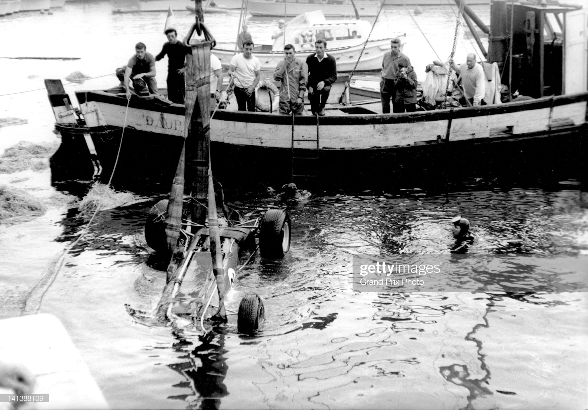 Lotus 33 Climax V8 of Paul Hawkins is recovered from the harbour after crashing on lap 79 during the Monaco Grand Prix on 30th May 1965.