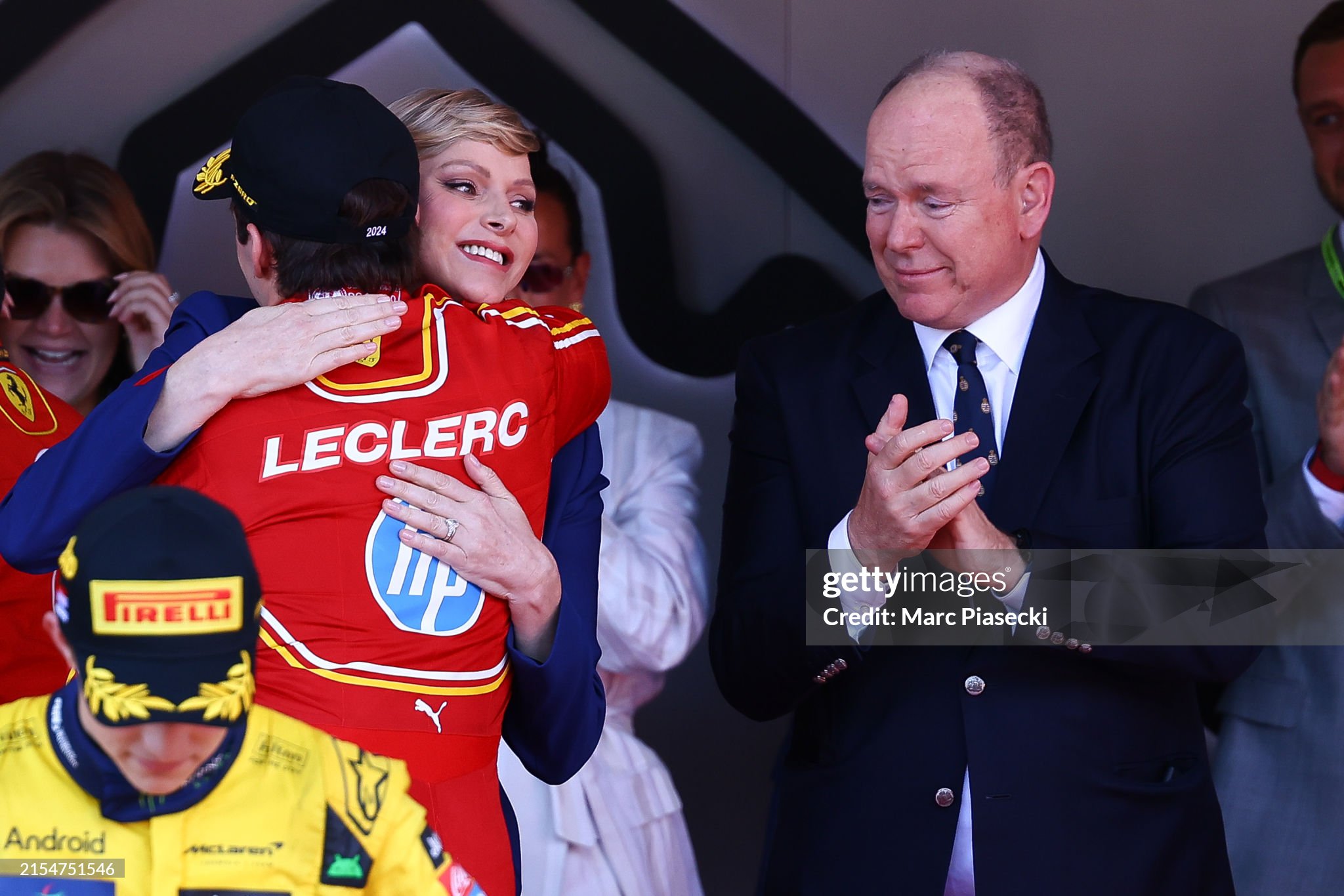 Charles Leclerc celebrates with a moved Prince Albert II of Monaco and Princess Charlene of Monaco on the podium after the F1 Grand Prix of Monaco on May 26, 2024. 