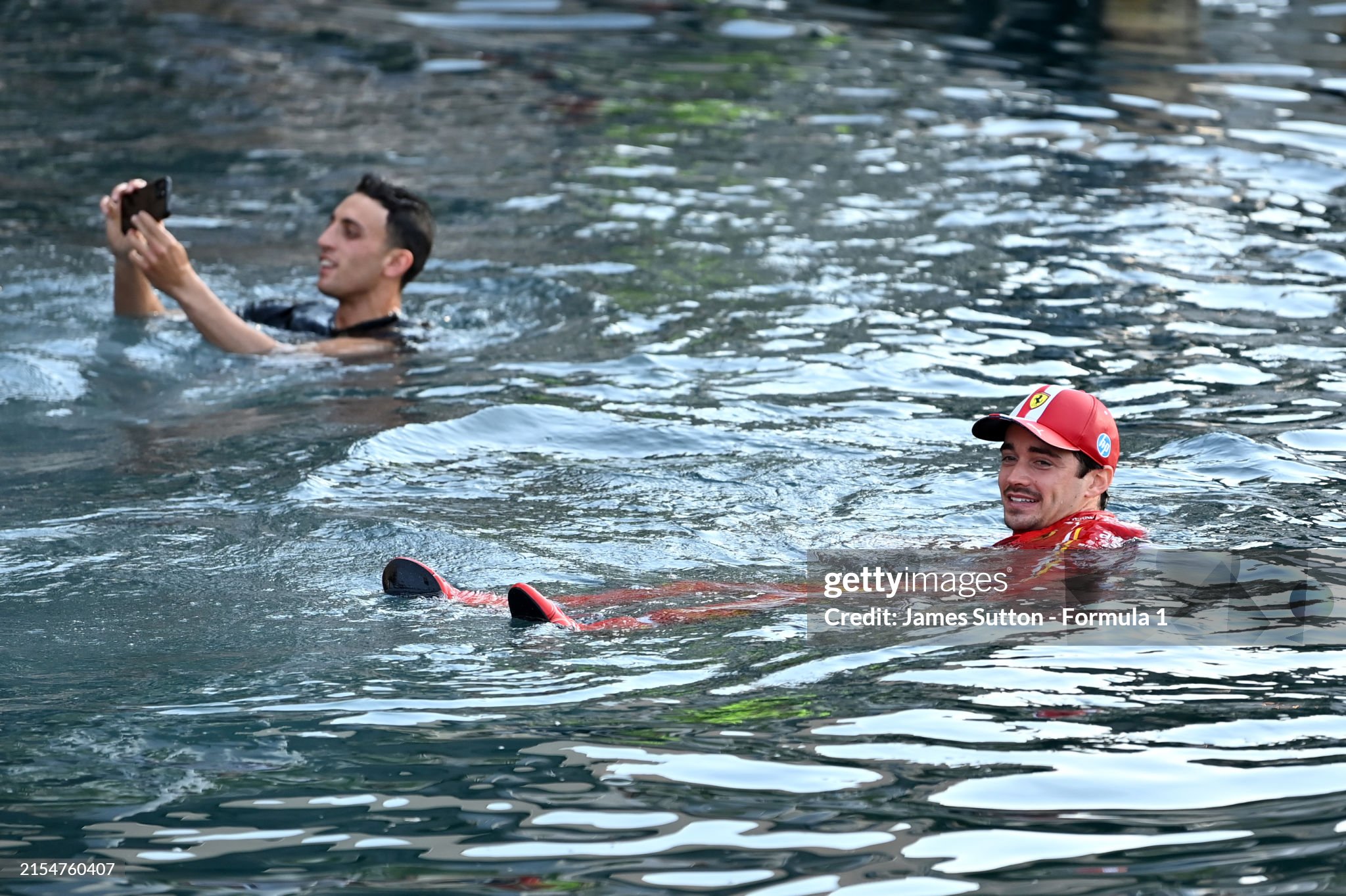 Charles Leclerc celebrates by jumping in the harbour after the F1 Grand Prix of Monaco on May 26, 2024. 