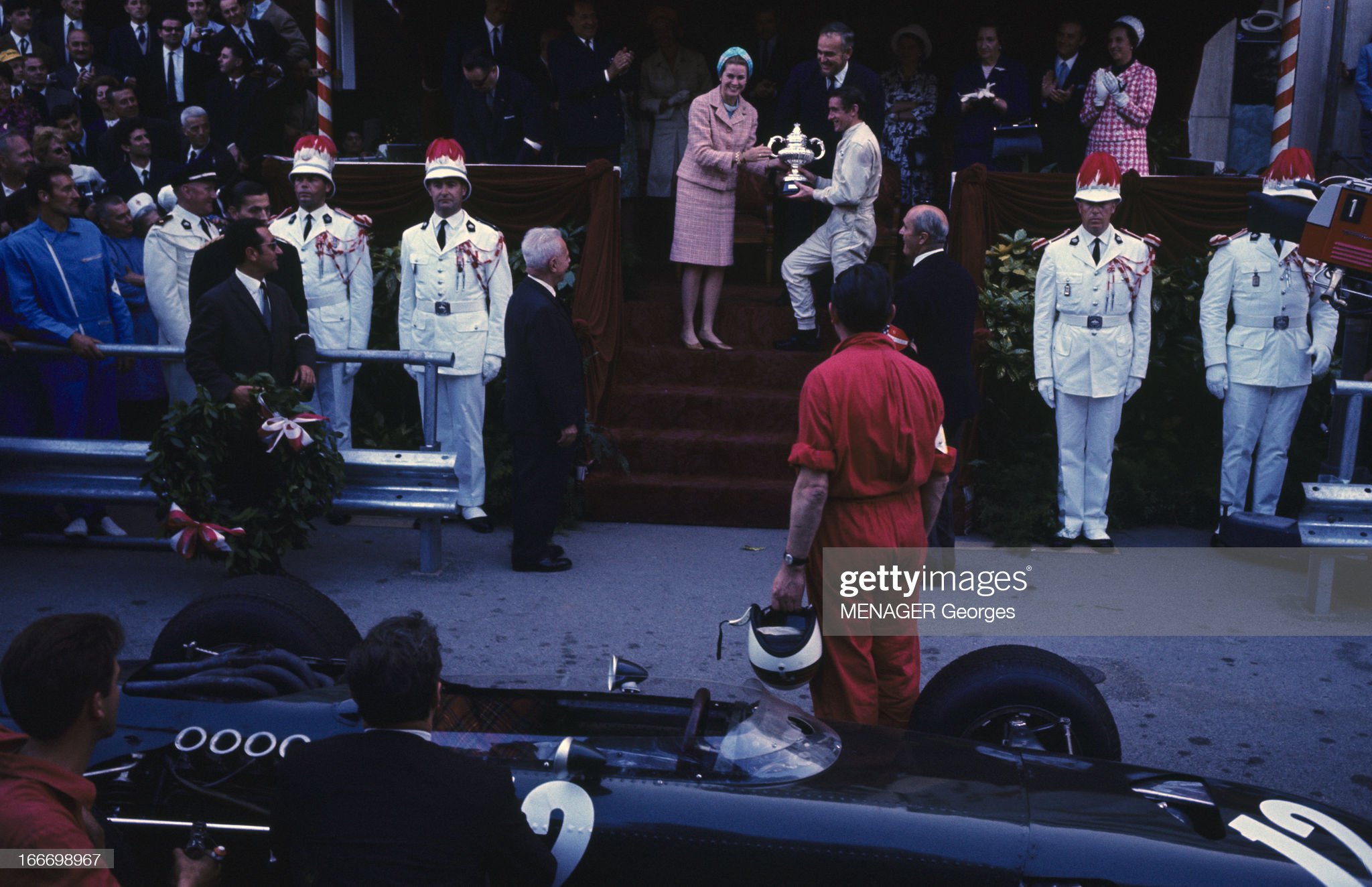 On May 22, 1966, after the Monaco Grand Prix, Jackie Stewart receives the cup from the hands of Grace Kelly, in front of Prince Rainier III. 
