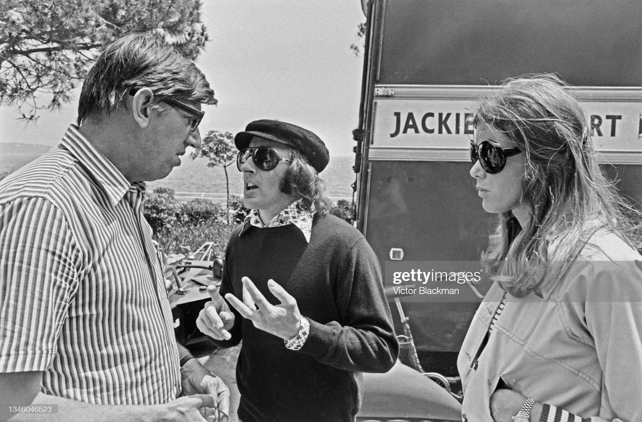 Ken Tyrrell (left) with Scottish racing driver Jackie Stewart and wife Helen during practice for the Monaco Grand Prix, 1st June 1973.