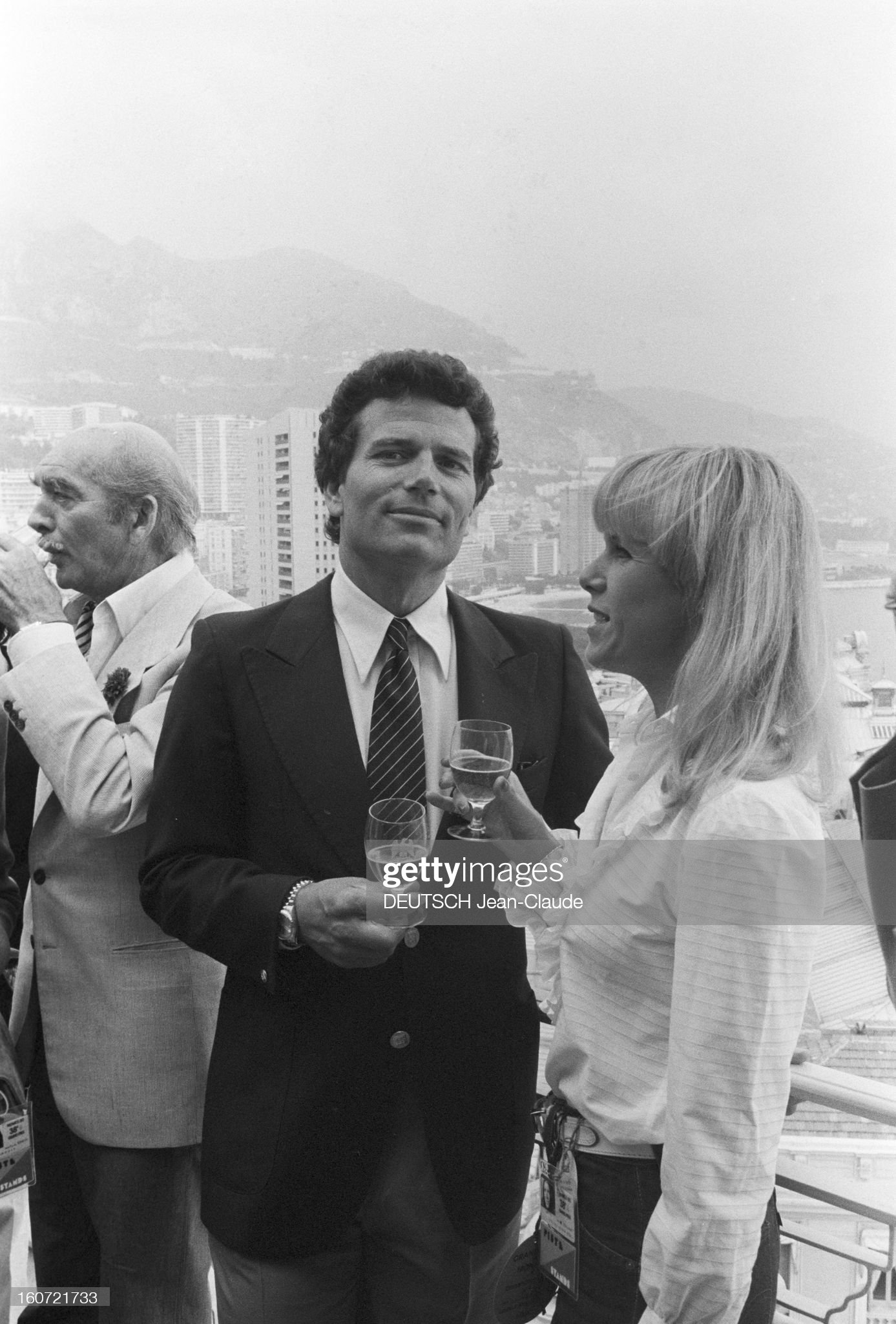 May 18, 1980, at the reception of Fred Chandon during the Monaco Formula 1 Grand Prix, on a terrace, Eddie Barclay, in profile, Patrick Wayne, a drink in his hand and an unidentified woman.