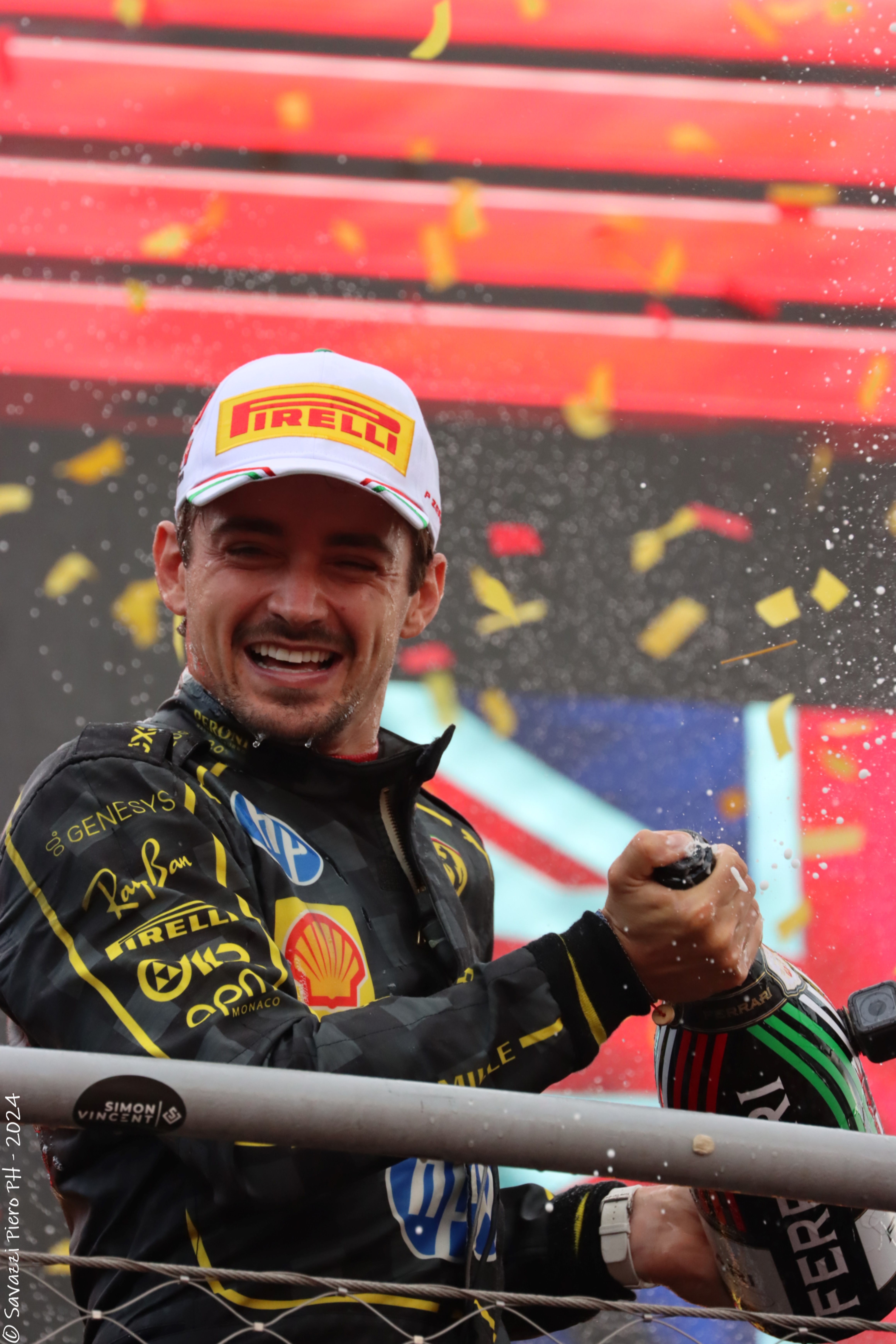 Charles Leclerc, winner of the 2024 Monza Grand Prix, celebrating on the podium. 