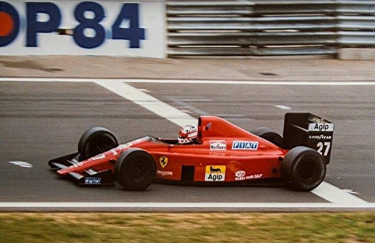 Nigel Mansell driving a Ferrari.